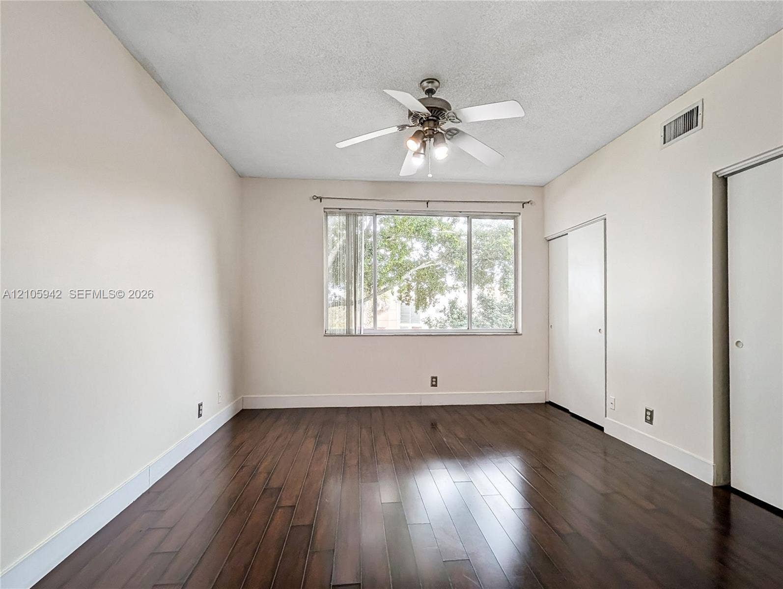 271 Duval Court, Weston, Weston, FL 33326 Room featuring wood-finish flooring, a ceiling fan with integrated light fixture, and a sliding-door closet