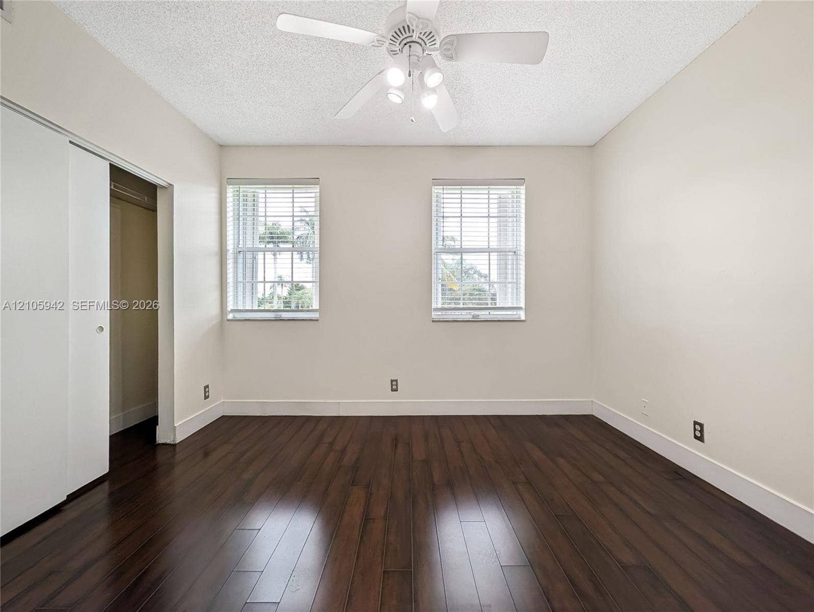271 Duval Court, Weston, Weston, FL 33326 Wood-finish flooring, dual windows with horizontal blinds, white sliding closet doors, and ceiling fan with integrated lighting