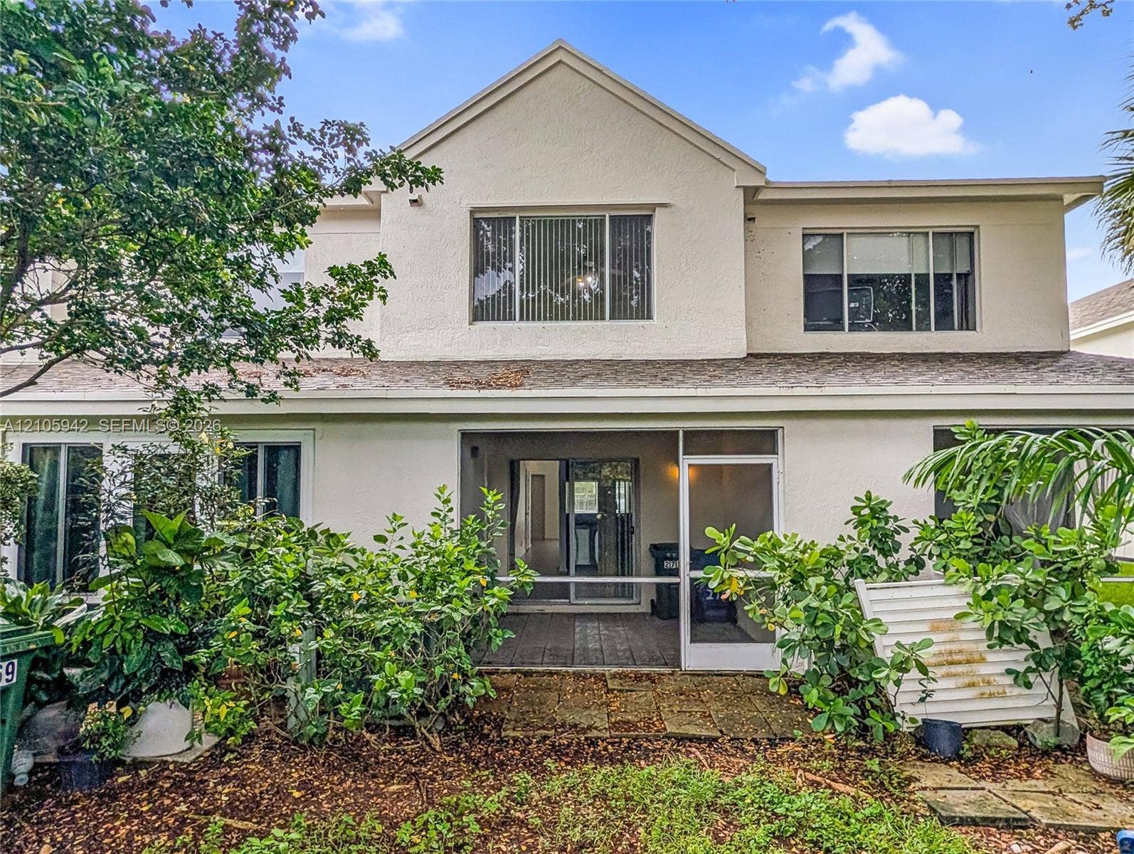 271 Duval Court, Weston, Weston, FL 33326 Rear exterior featuring a covered patio, stucco siding, multi-level design, and private chain-link fencing