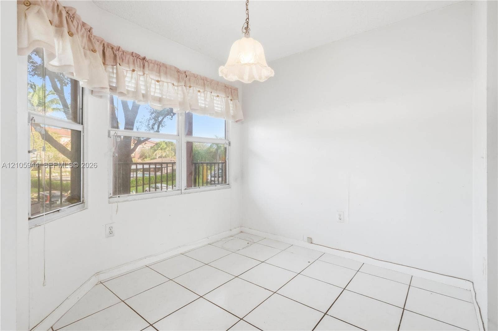 Bay window featuring multi-pane glass, ceramic tile flooring, and a single pendant light fixture