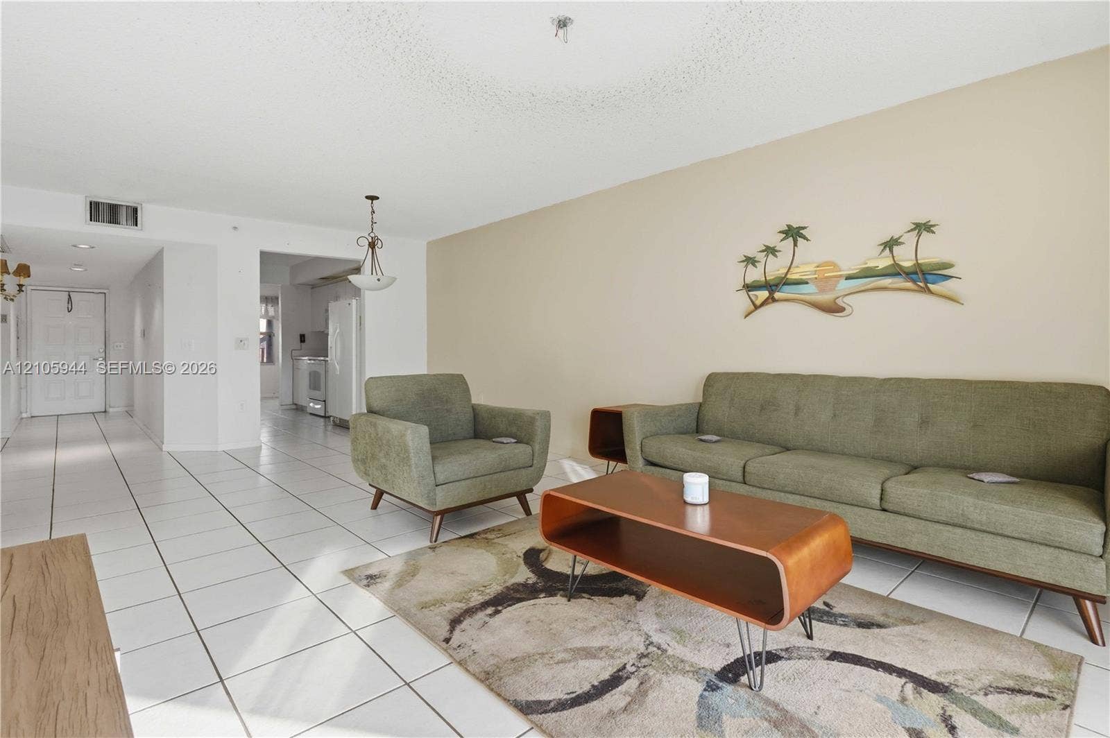 Open-concept interior featuring white floor tile, a recessed lighting fixture, and neutral wall tones