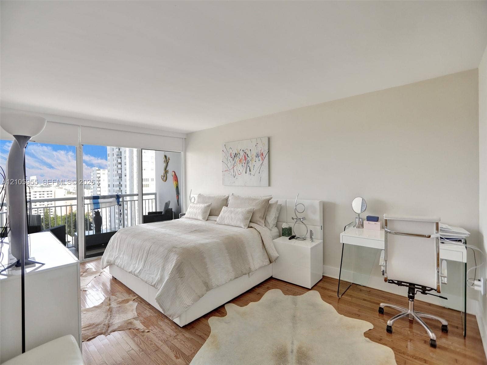 18011 Biscayne Boulevard, #1904, Aventura, FL 33160 Wood-finish flooring, floor-to-ceiling glass sliding doors, and private balcony with metal railing
