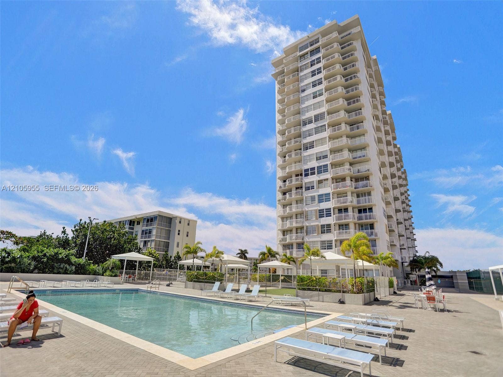 18011 Biscayne Boulevard, #1904, Aventura, FL 33160 High-rise residential building featuring multiple private balconies, a ground-level swimming pool, and dedicated cabana structures