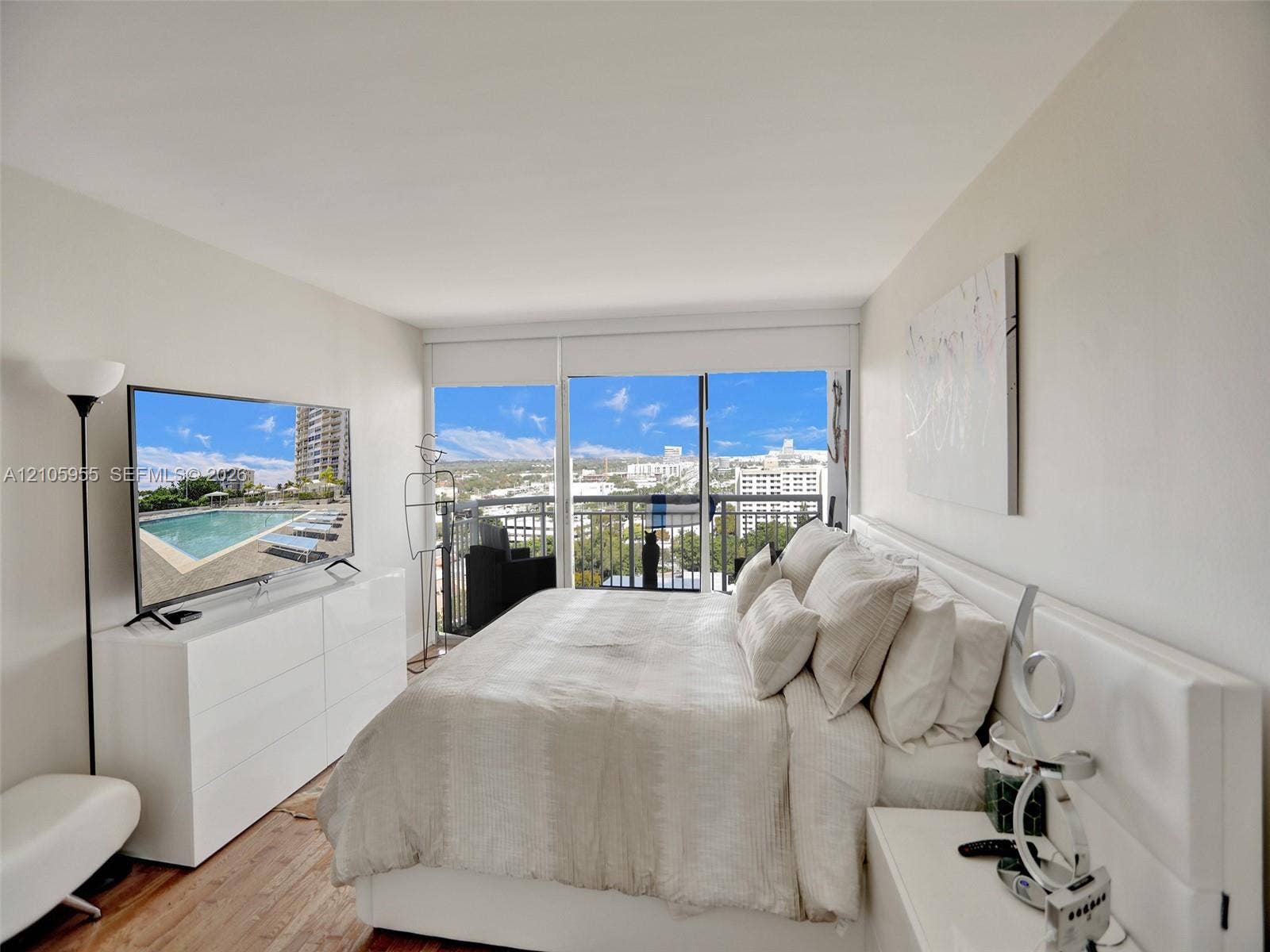18011 Biscayne Boulevard, #1904, Aventura, FL 33160 Floor-to-ceiling glass sliding doors, wood-finish flooring, metal balcony railing, and natural lighting