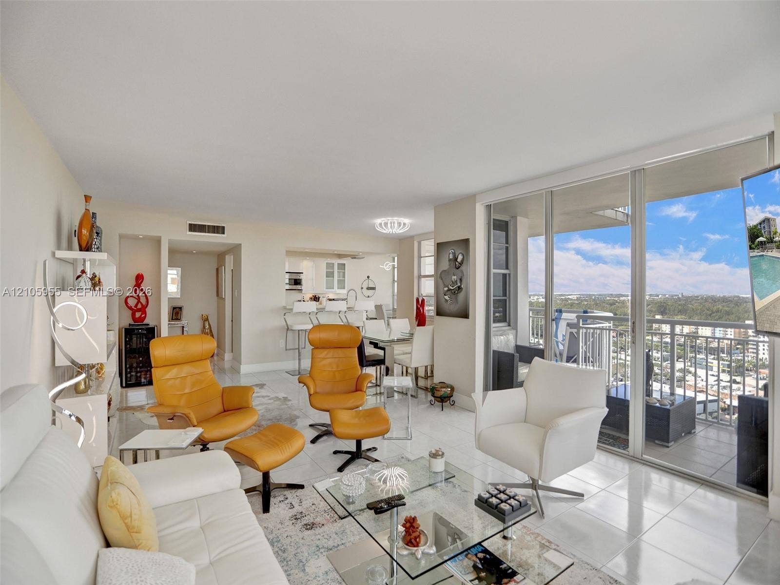 18011 Biscayne Boulevard, #1904, Aventura, FL 33160 Open-concept interior featuring large-format tile flooring, recessed lighting, expansive floor-to-ceiling glass sliding doors, and a built-in refrigerated wine storage unit