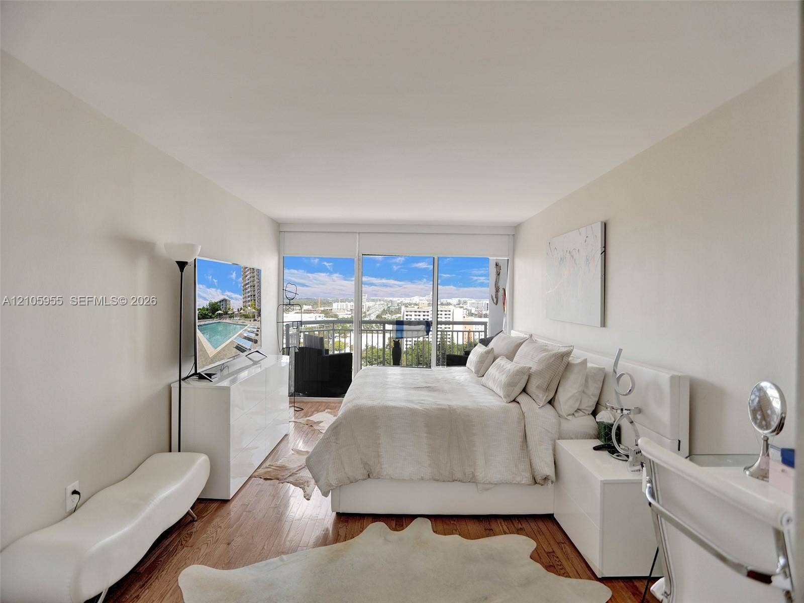 18011 Biscayne Boulevard, #1904, Aventura, FL 33160 Floor-to-ceiling windows, wood-finish flooring, and an attached balcony featuring a metal railing