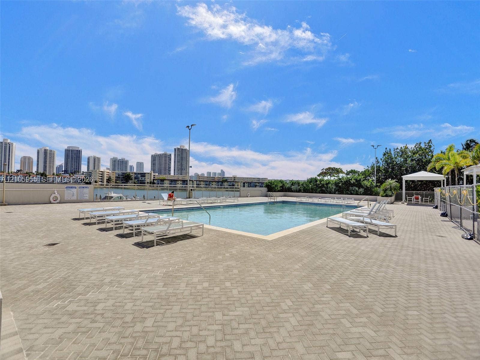 18011 Biscayne Boulevard, #1904, Aventura, FL 33160 Swimming pool with a paved deck, perimeter fencing, and an overhead pavilion structure