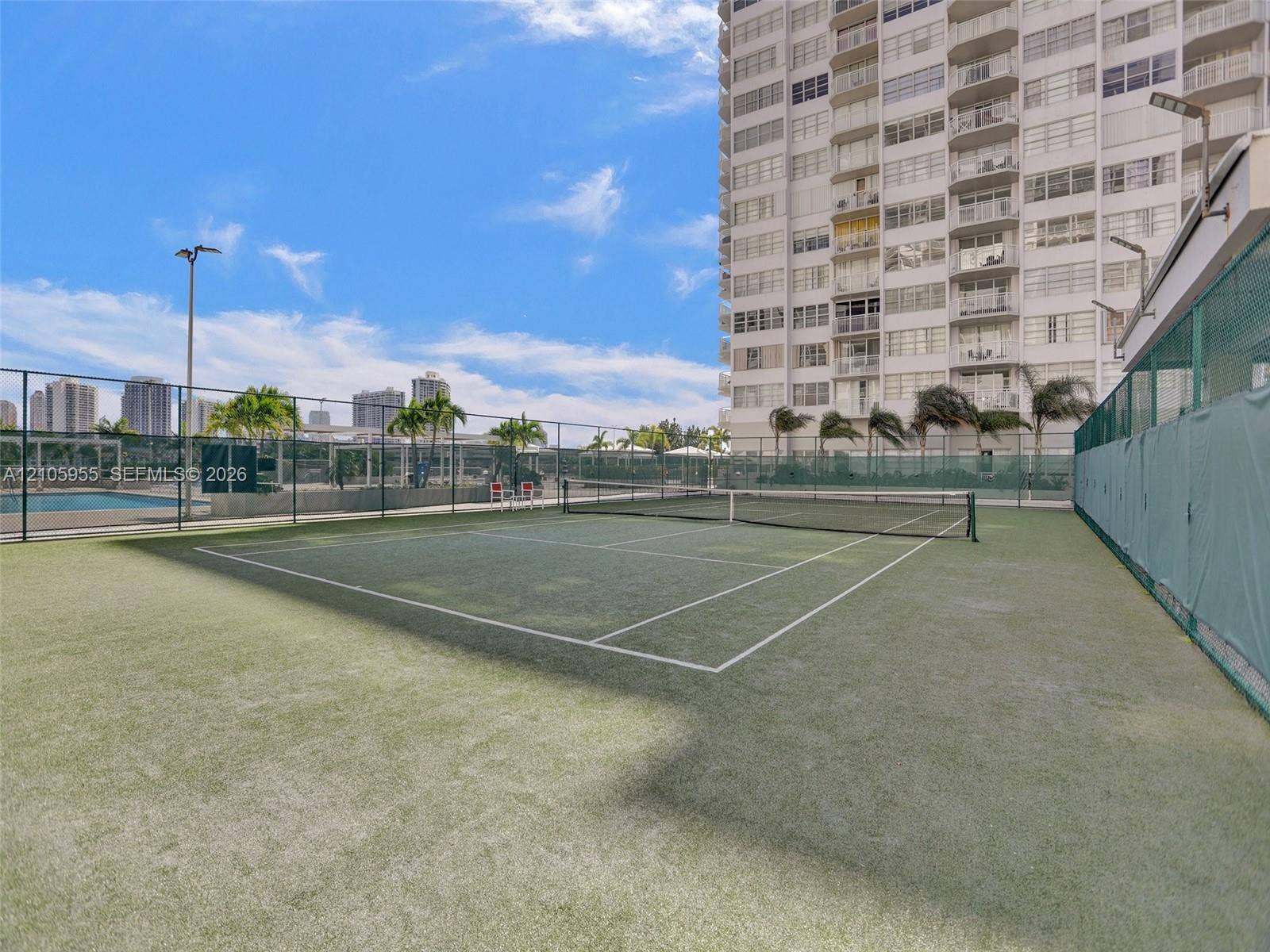 18011 Biscayne Boulevard, #1904, Aventura, FL 33160 Tennis court with synthetic turf surface, enclosed by perimeter chain-link fencing