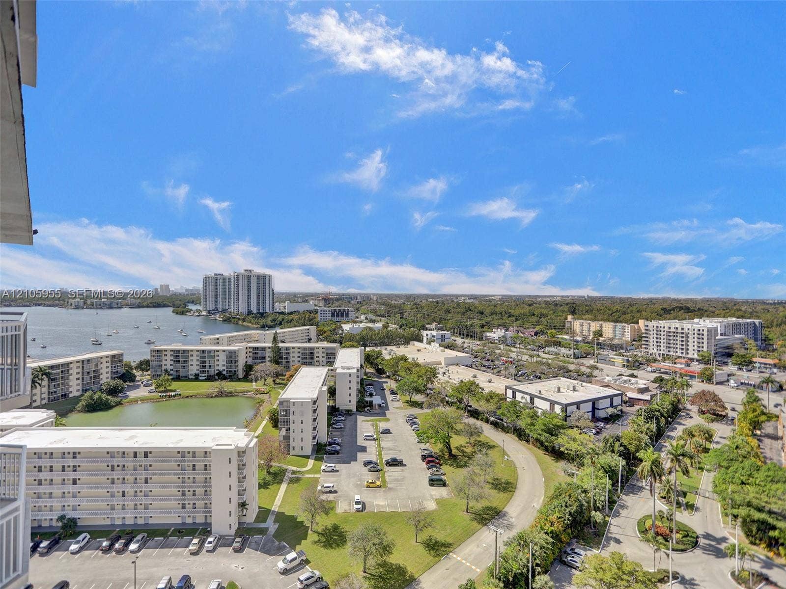 18011 Biscayne Boulevard, #1904, Aventura, FL 33160 Elevated exterior perspective featuring expansive water scenery, multi-level residential structures, and landscaped grounds with mature palms