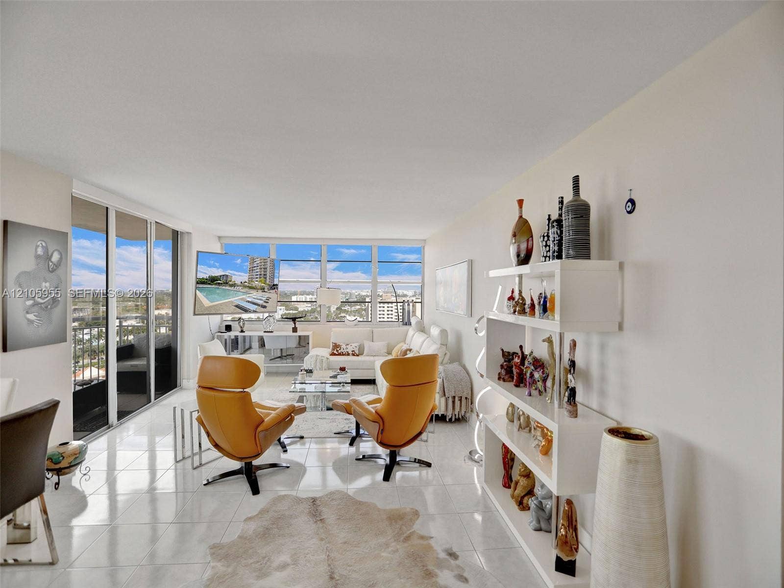 18011 Biscayne Boulevard, #1904, Aventura, FL 33160 Expansive living space featuring polished tile flooring, floor-to-ceiling windows, and access to a private balcony