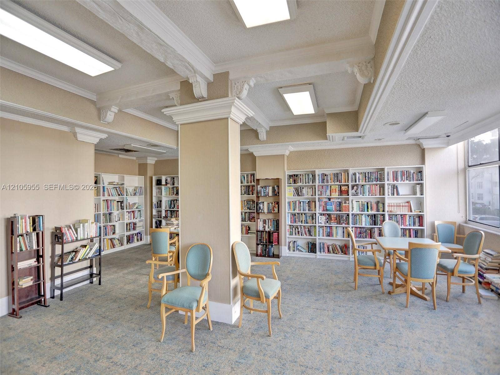 18011 Biscayne Boulevard, #1904, Aventura, FL 33160 Built-in floor-to-ceiling shelving, decorative ceiling beams with crown molding, and large window placement providing natural light