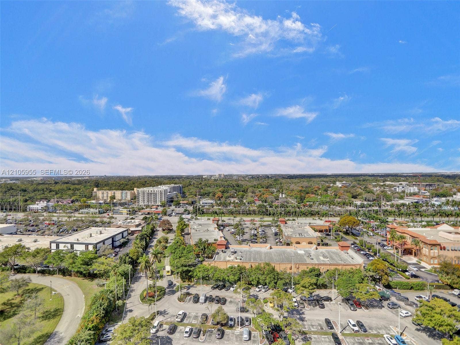 18011 Biscayne Boulevard, #1904, Aventura, FL 33160 Aerial perspective of the surrounding commercial district featuring expansive paved parking areas, dense perimeter landscaping, and established tree canopy