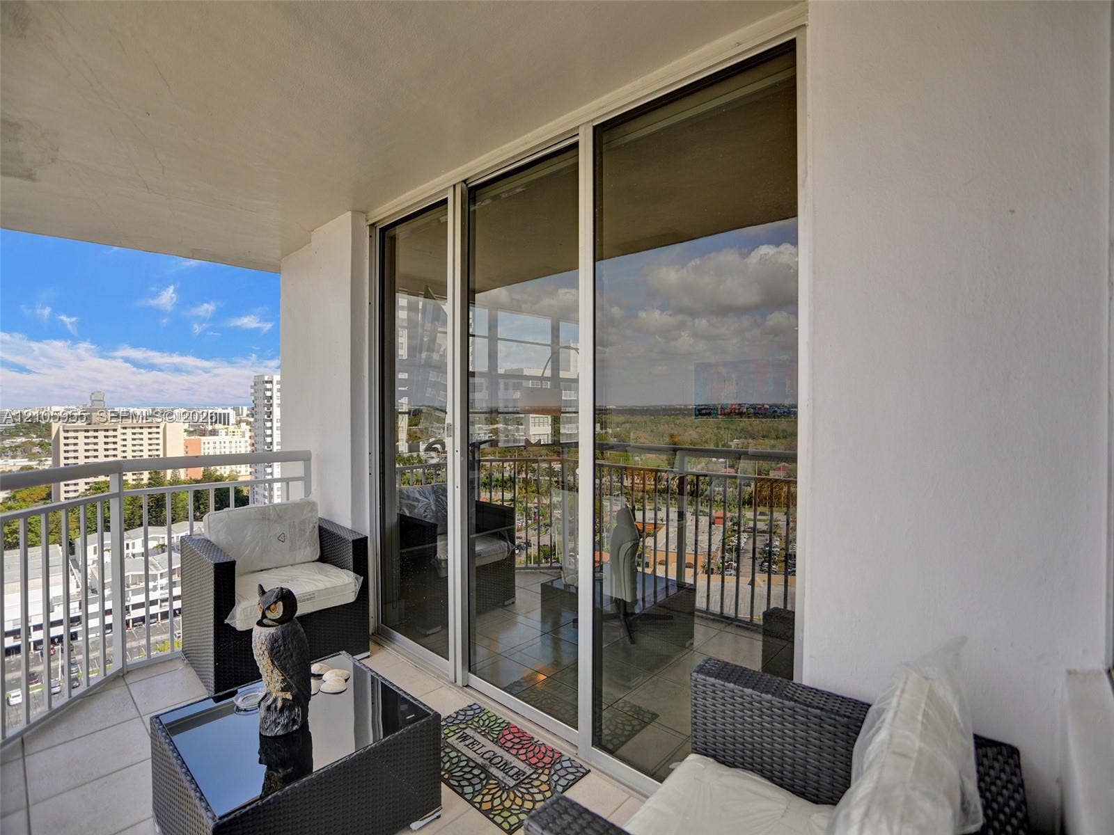 18011 Biscayne Boulevard, #1904, Aventura, FL 33160 Private balcony featuring large-format tile flooring, metal railings, and full-height sliding glass doors