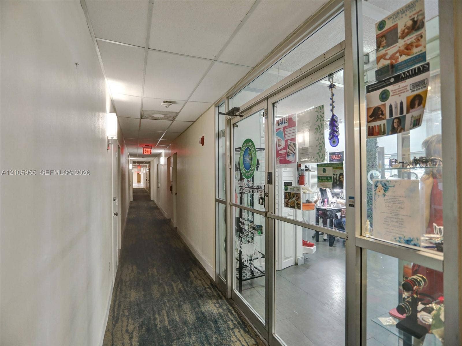 18011 Biscayne Boulevard, #1904, Aventura, FL 33160 Commercial hallway featuring drop-ceiling tiles, recessed lighting, and glass-paneled entry doors with aluminum framing
