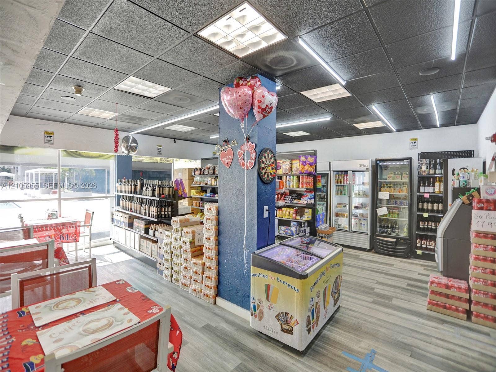 18011 Biscayne Boulevard, #1904, Aventura, FL 33160 Commercial interior featuring wood-finish flooring, grid-panel drop ceiling, recessed linear lighting, and floor-to-ceiling glass wall panels
