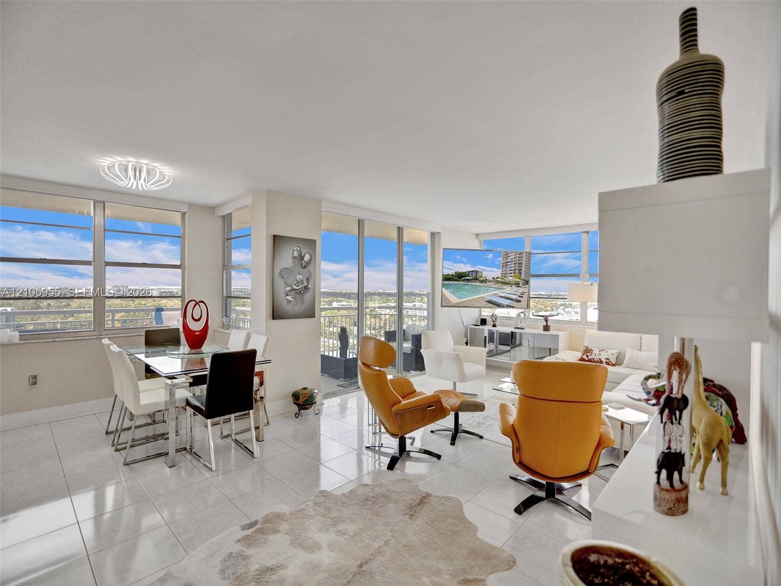 18011 Biscayne Boulevard, #1904, Aventura, FL 33160 Open-concept interior featuring large-format ceramic tile flooring, floor-to-ceiling windows, a private balcony, and contemporary overhead lighting