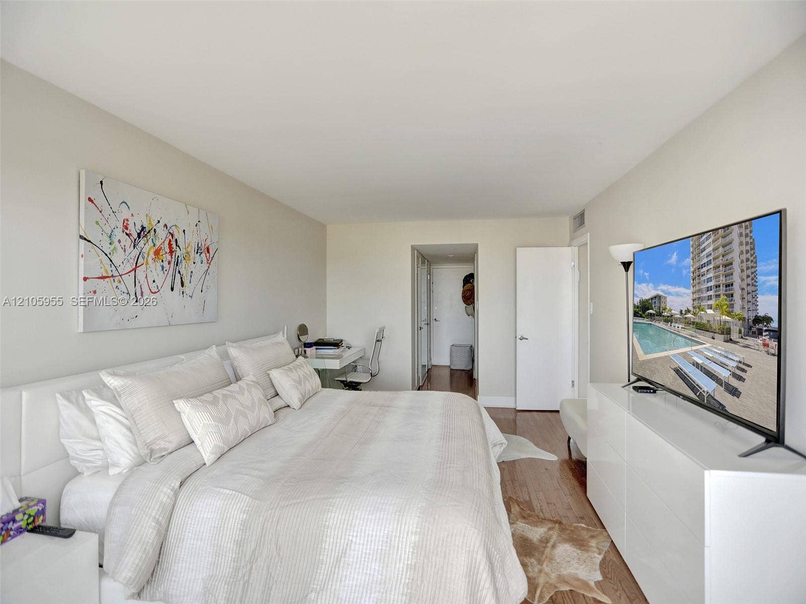 18011 Biscayne Boulevard, #1904, Aventura, FL 33160 Neutral-toned bedroom featuring hardwood flooring and solid-core interior doors