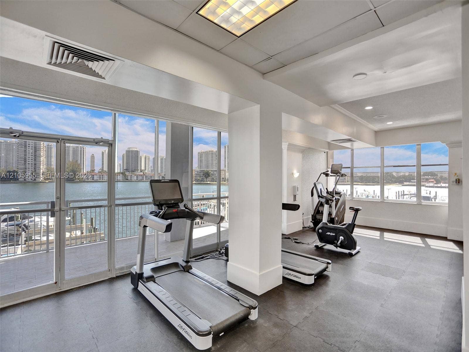 18011 Biscayne Boulevard, #1904, Aventura, FL 33160 Fitness center featuring floor-to-ceiling windows, rubberized flooring, recessed lighting, and water frontage