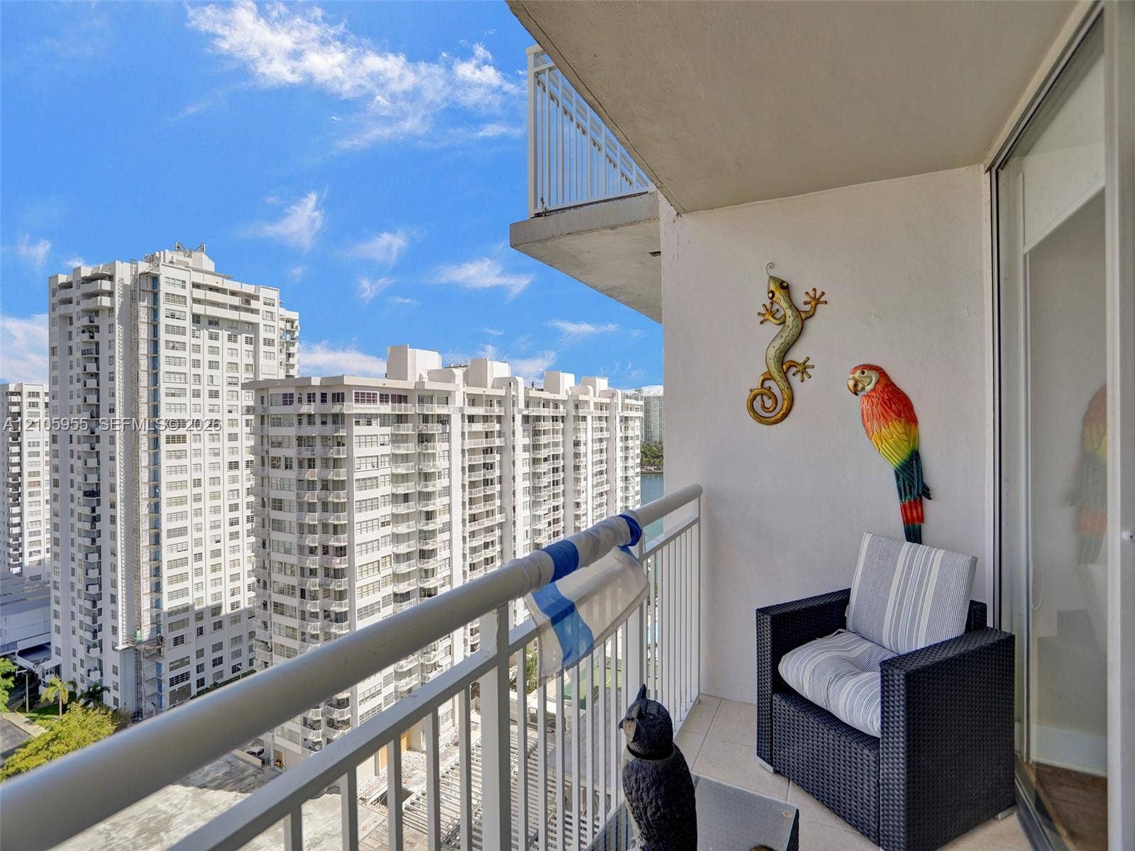 18011 Biscayne Boulevard, #1904, Aventura, FL 33160 Covered balcony featuring white metal railings and tiled flooring
