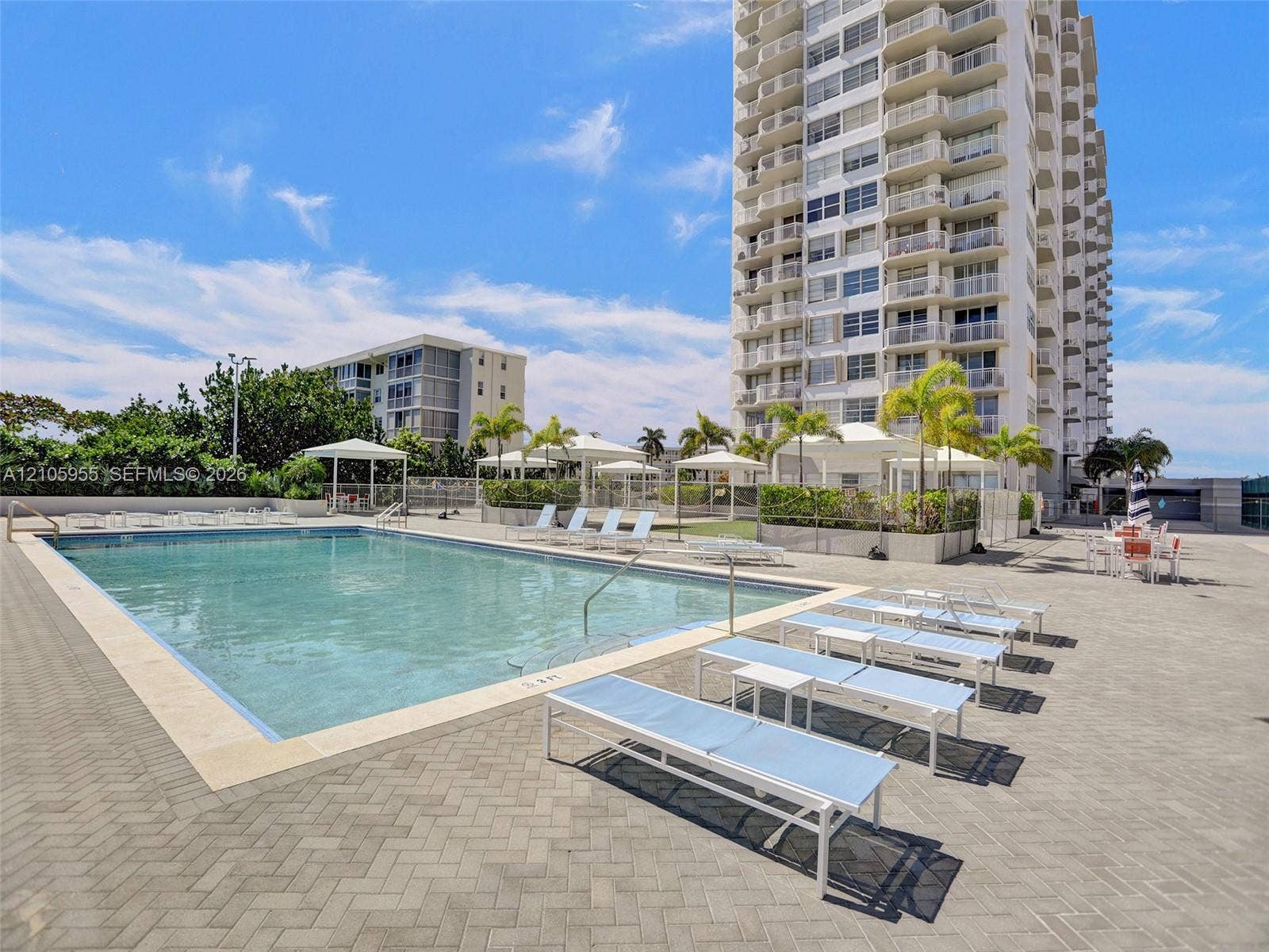 18011 Biscayne Boulevard, #1904, Aventura, FL 33160 Swimming pool with stone decking, surrounding pergolas, and manicured landscaping