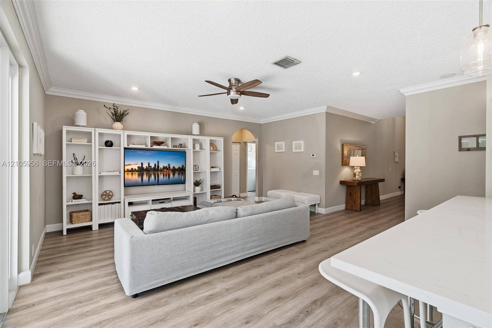 1154 Croton Court, Weston, Weston, FL 33327 Living area featuring wood-finish flooring, white built-in cabinetry, crown molding, a ceiling fan, and recessed lighting