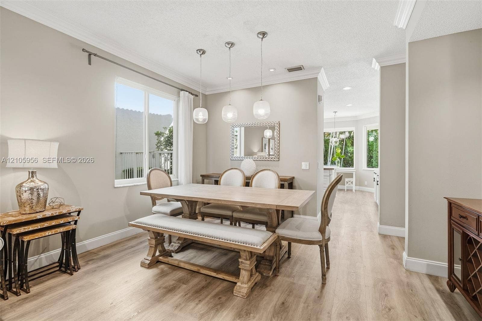 1154 Croton Court, Weston, Weston, FL 33327 Dining area featuring wood-finish flooring, crown molding, and three globe pendant light fixtures