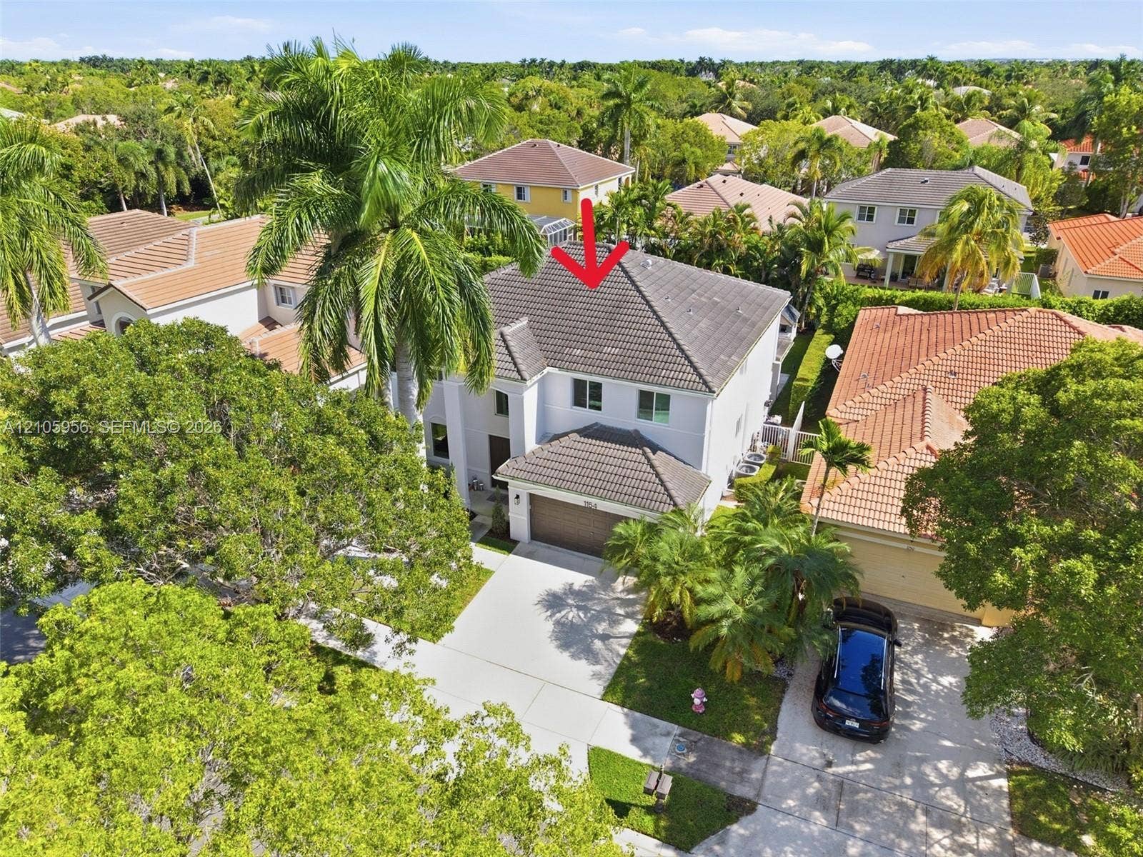 1154 Croton Court, Weston, Weston, FL 33327 Two-story residence featuring a hipped tile roof, stucco exterior, integrated two-car garage, and a concrete driveway