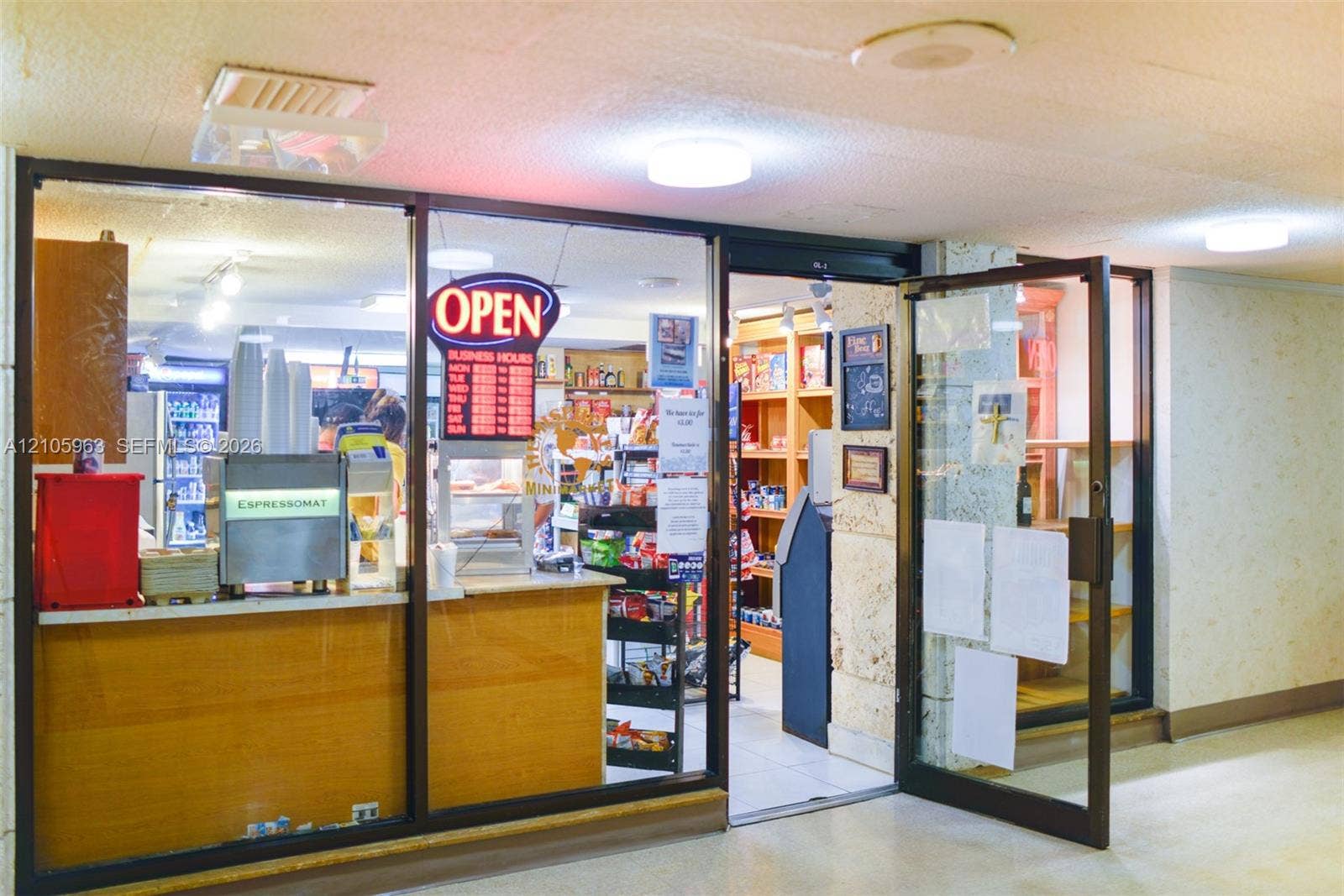 1980 S Ocean Drive, #PHA, Hallandale Beach, Hallandale Beach, FL 33009 Commercial storefront featuring glass-paneled entry door, aluminum framing, recessed ceiling lighting, and built-in service counter with wood-finish cabinetry