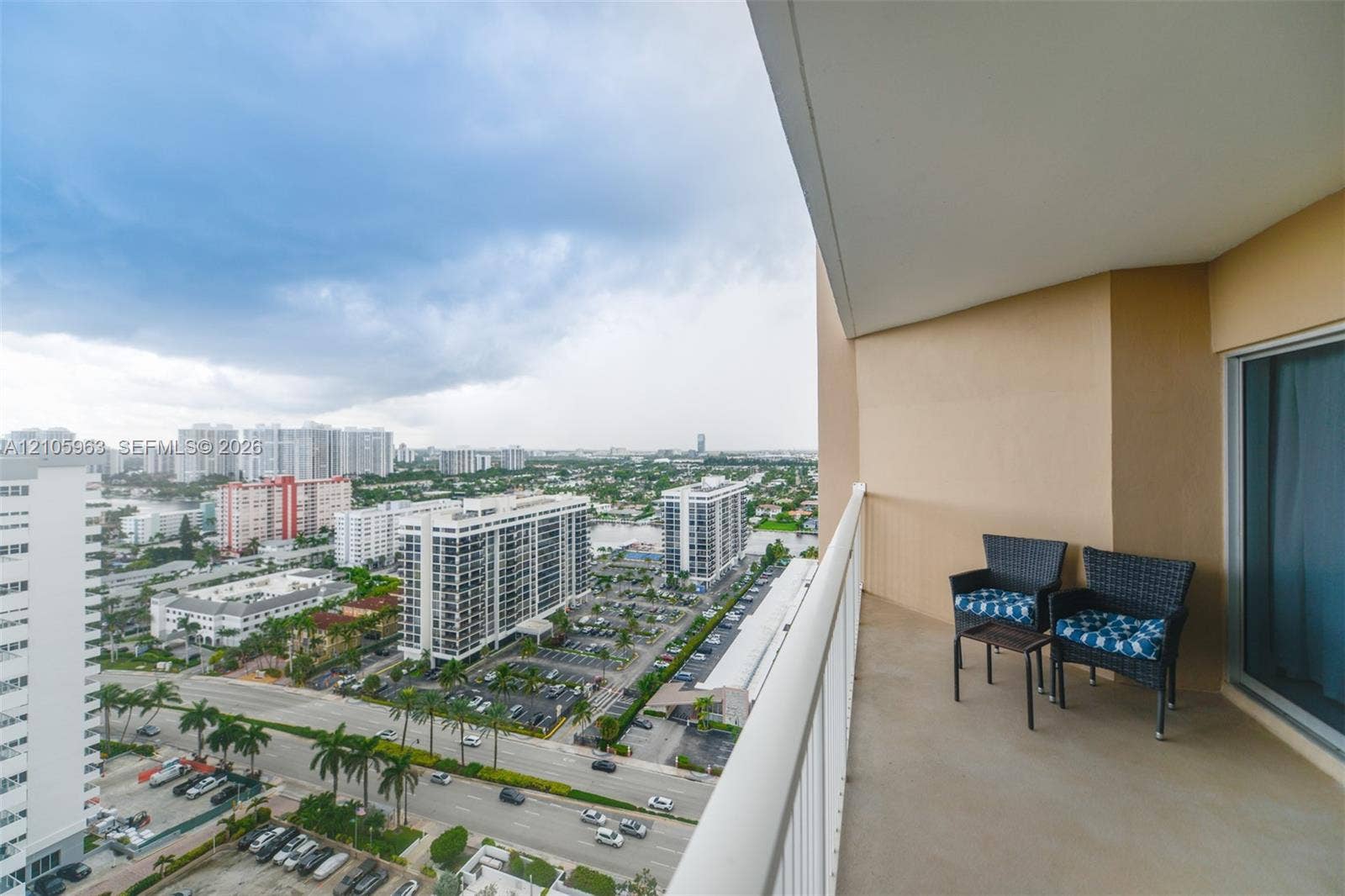 1980 S Ocean Drive, #PHA, Hallandale Beach, Hallandale Beach, FL 33009 Covered balcony featuring concrete flooring, a protective metal railing, and high-rise urban surroundings