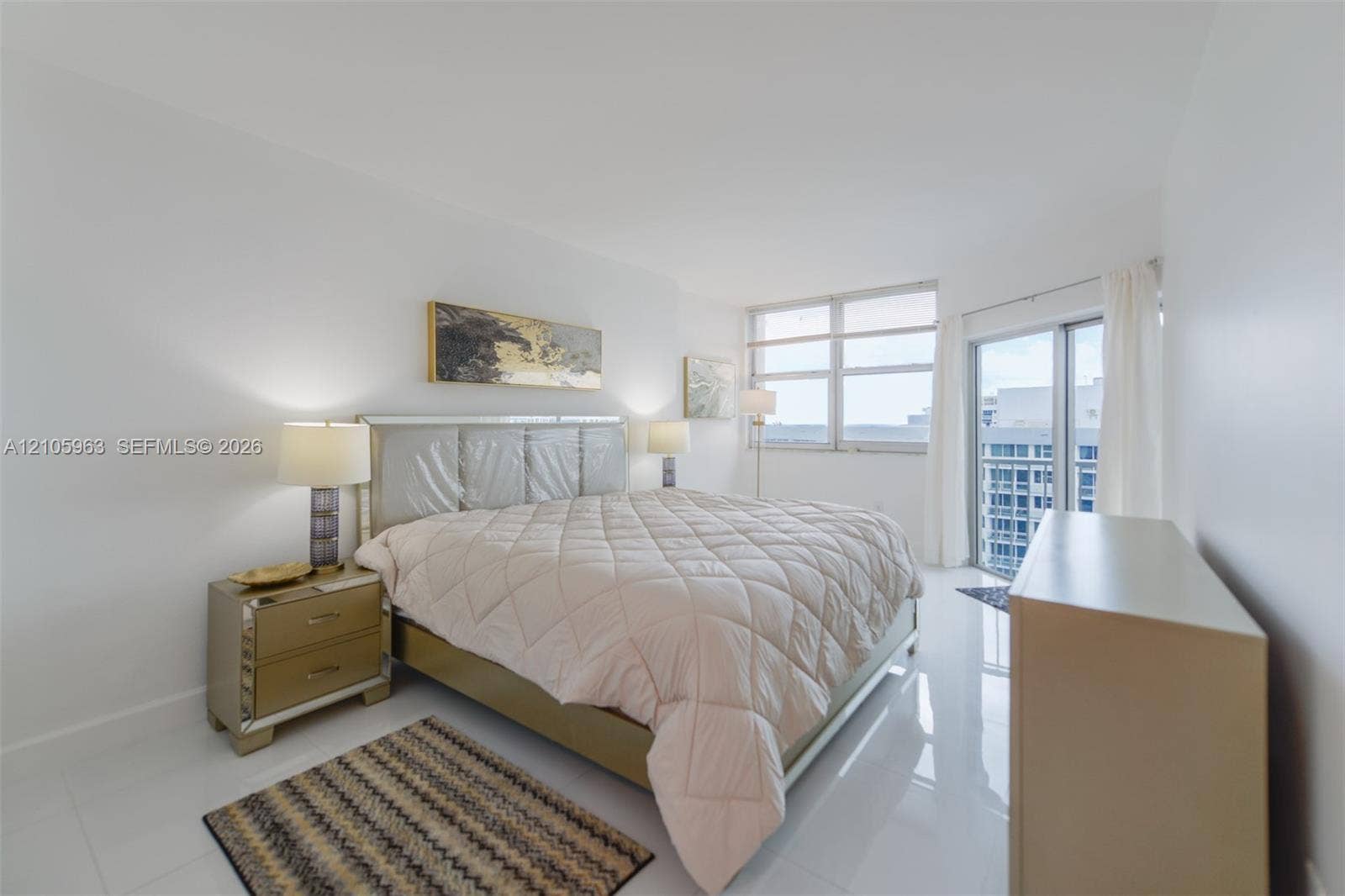 1980 S Ocean Drive, #PHA, Hallandale Beach, Hallandale Beach, FL 33009 Spacious room featuring polished tile flooring, expansive floor-to-ceiling windows, and sliding glass door access to a balcony