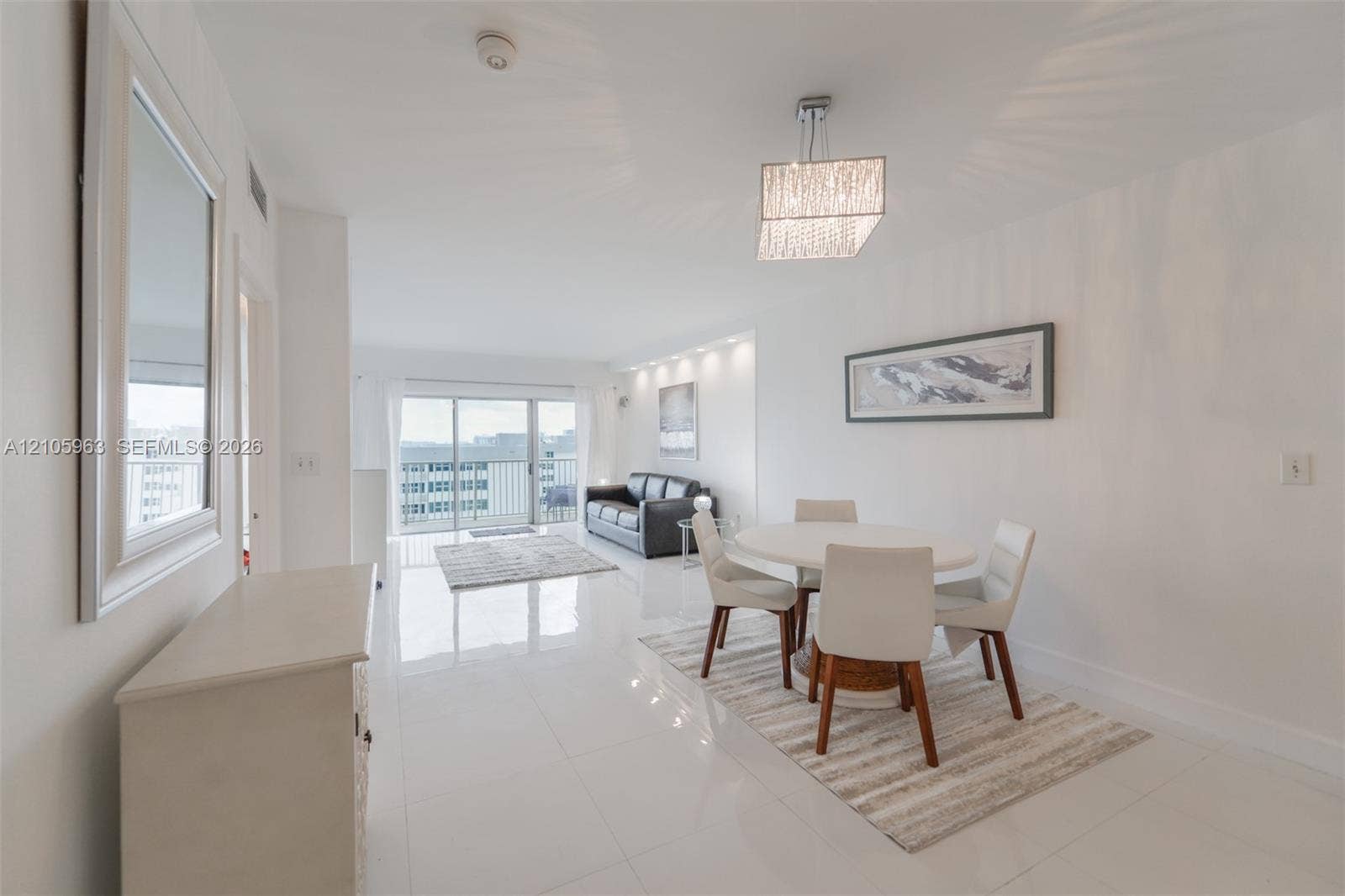 1980 S Ocean Drive, #PHA, Hallandale Beach, Hallandale Beach, FL 33009 Open-concept living space featuring high-gloss tile flooring, recessed ceiling lighting, a tiered crystal-style chandelier, and sliding glass balcony doors