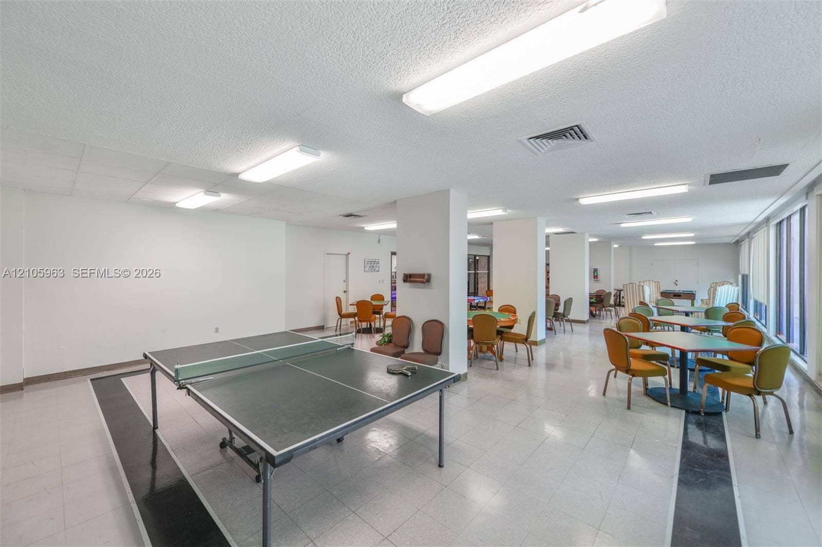 1980 S Ocean Drive, #PHA, Hallandale Beach, Hallandale Beach, FL 33009 Large open-concept interior featuring light-colored tile flooring with decorative dark accents, structural support pillars, and linear ceiling-mounted lighting