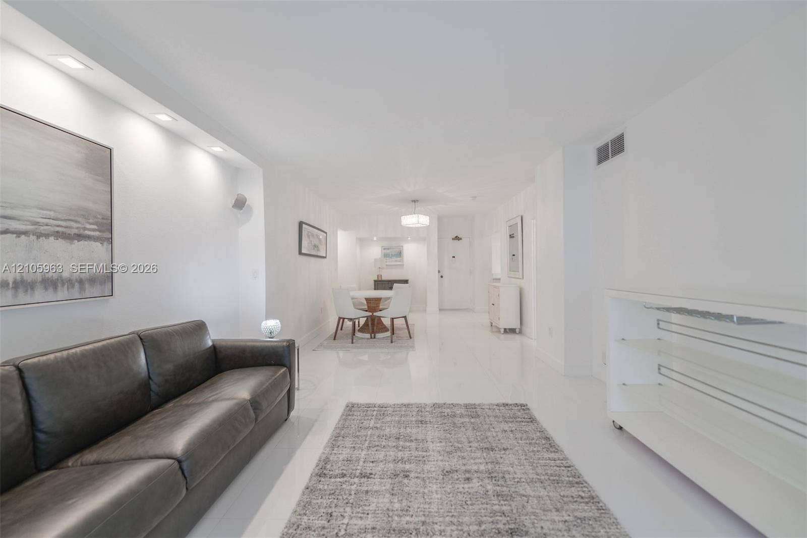 1980 S Ocean Drive, #PHA, Hallandale Beach, Hallandale Beach, FL 33009 Open-concept interior featuring smooth-finish tile flooring, recessed ceiling lighting, and a built-in glass shelving unit