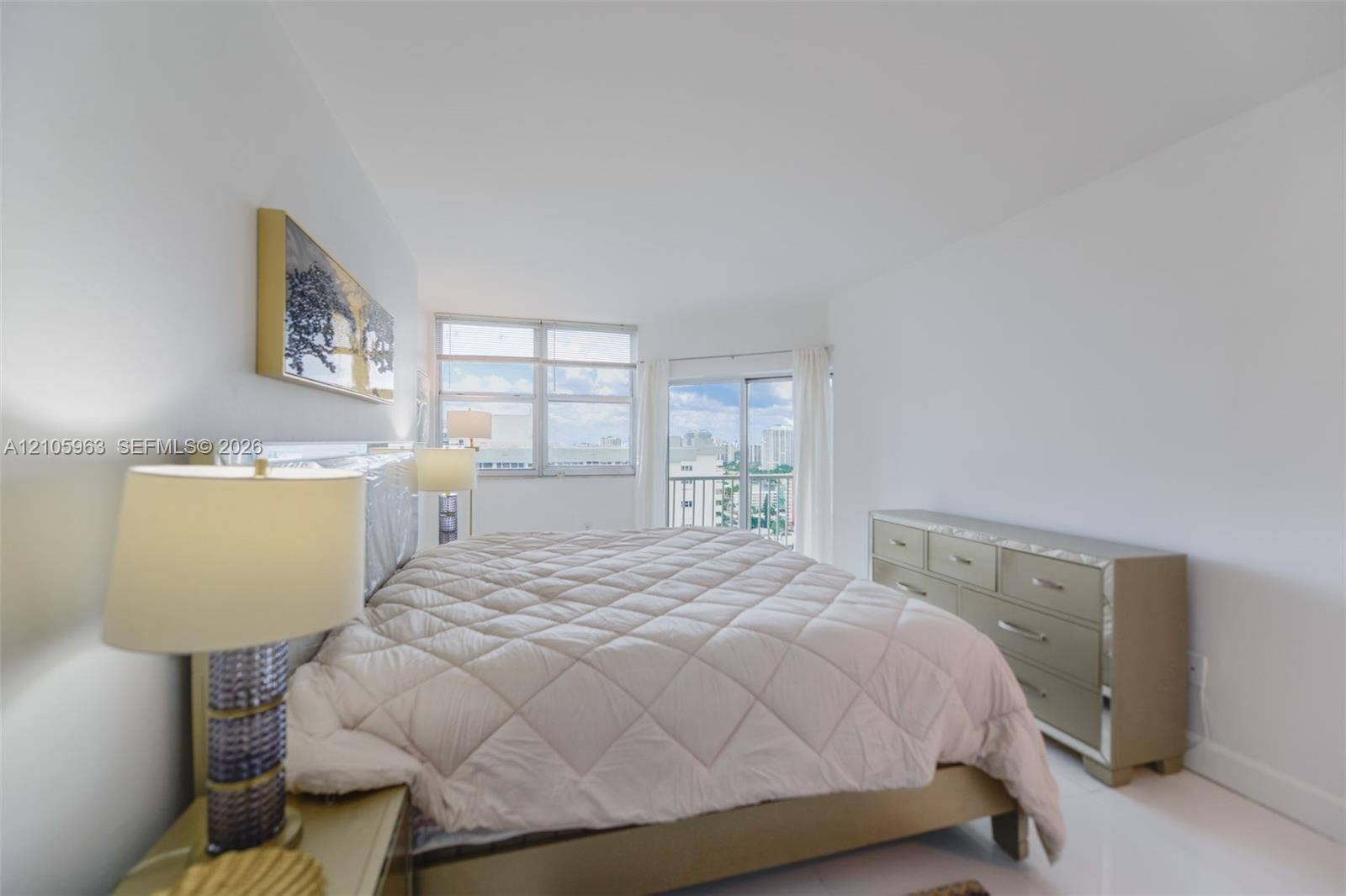1980 S Ocean Drive, #PHA, Hallandale Beach, Hallandale Beach, FL 33009 Neutral interior featuring high-gloss flooring, floor-to-ceiling windows, and sliding glass doors with access to an exterior balcony