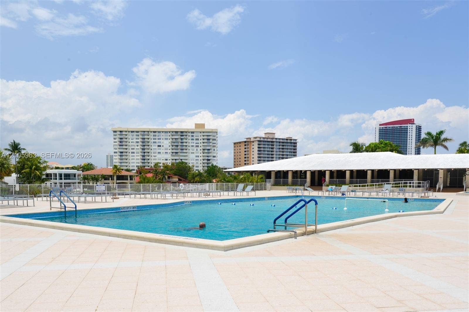 1980 S Ocean Drive, #PHA, Hallandale Beach, Hallandale Beach, FL 33009 Rectangular swimming pool featuring a light-toned paved deck, metal railings, and a covered pavilion