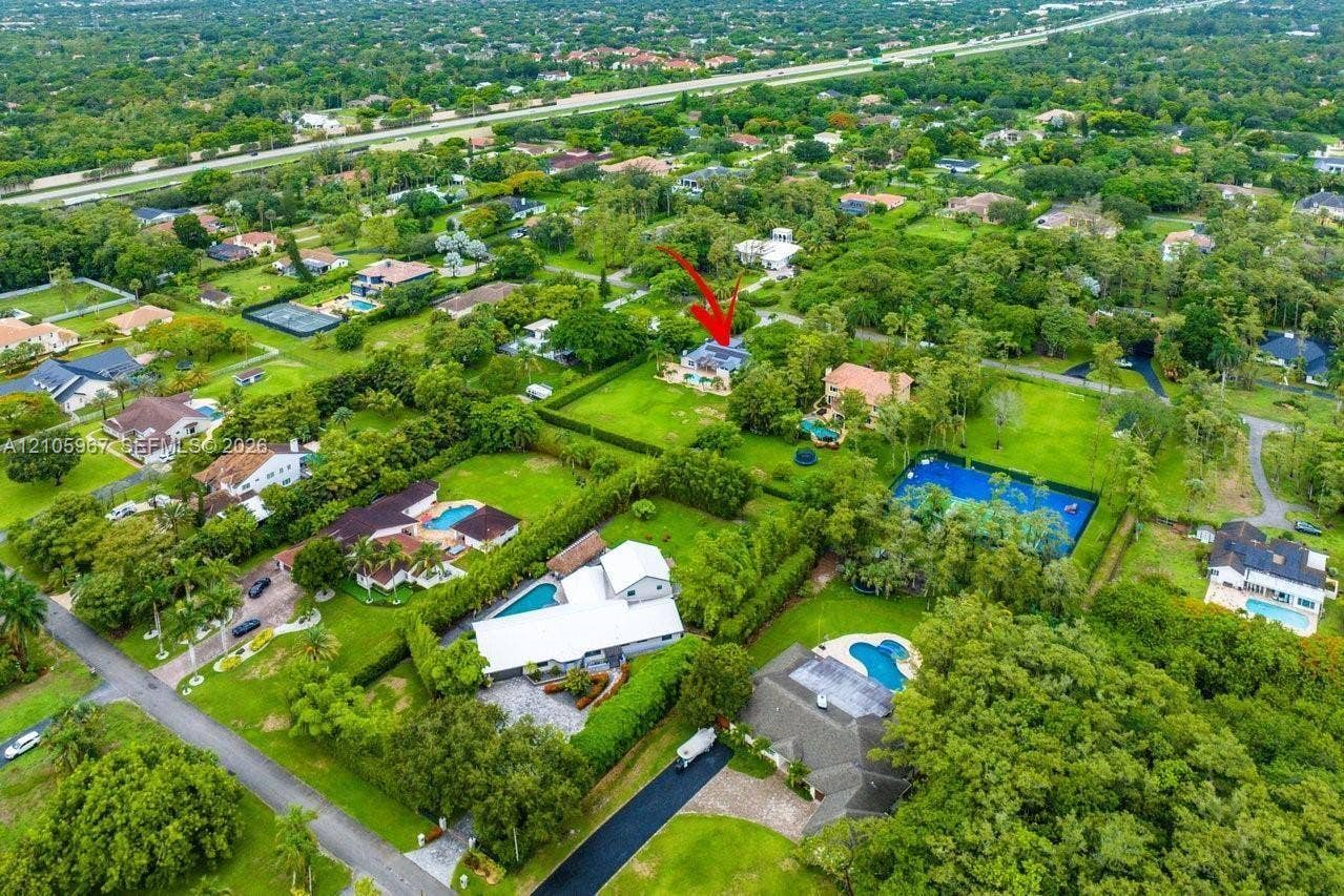 5966 NW 77th Terrace, Parkland, Parkland, FL 33067 Aerial perspective of a multi-structure property featuring a detached residence, extensive green space, mature landscaping, and mature trees