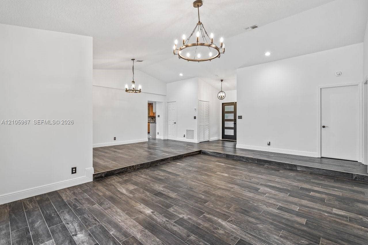 5966 NW 77th Terrace, Parkland, Parkland, FL 33067 Vaulted ceilings, wood-finish tile flooring, recessed lighting, and multi-arm chandelier fixtures