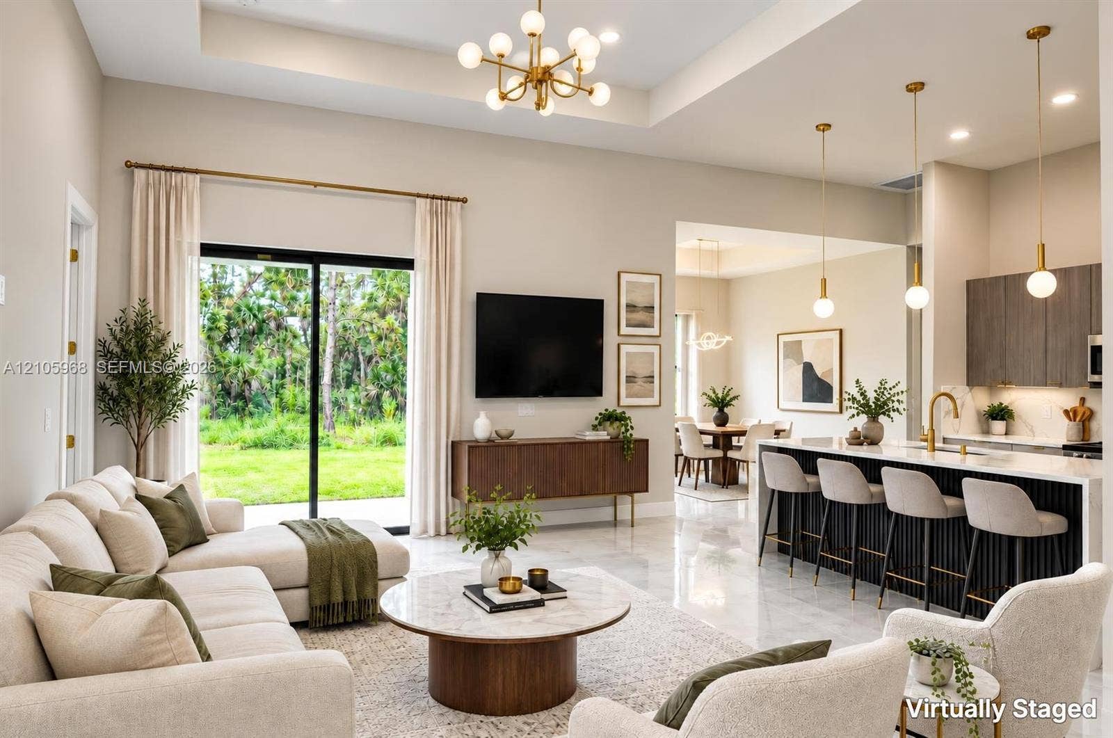 3509 63rd Street W, Lehigh Acres, FL 33971 Open-concept living space featuring high tray ceilings, polished tile flooring, a kitchen island with vertical slat detailing, and sliding glass doors
