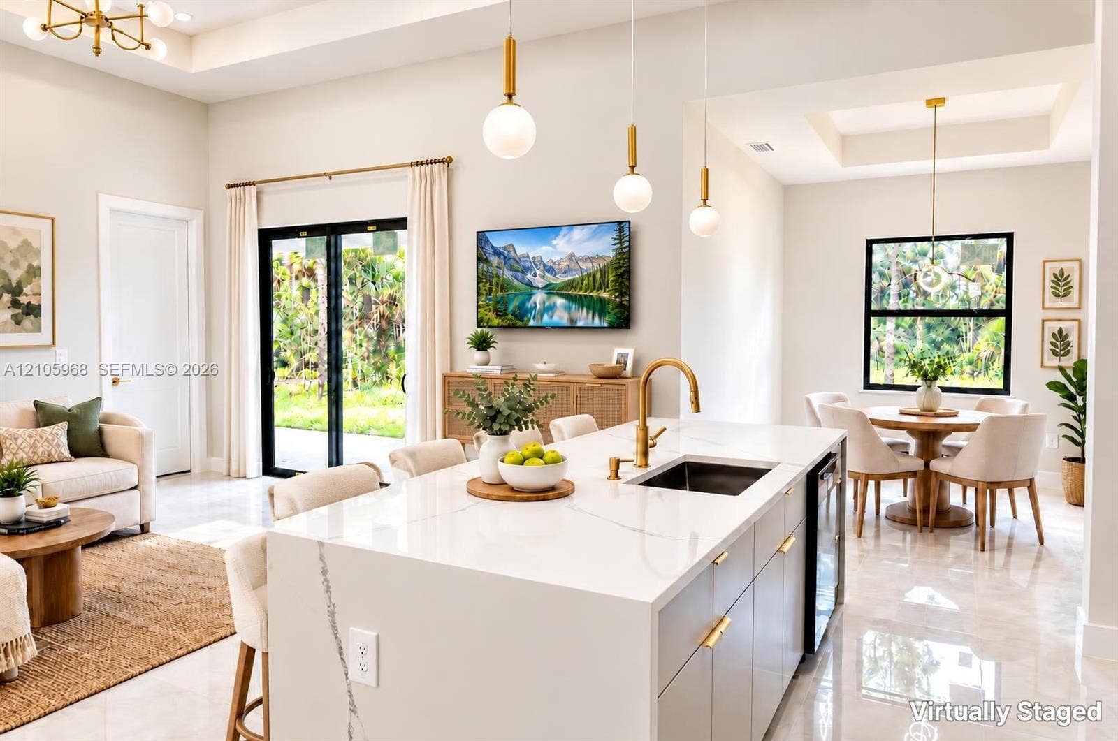 3509 63rd Street W, Lehigh Acres, FL 33971 Open-concept kitchen featuring a waterfall-edge island with stone-finish countertops, brass-finish faucet, pendant lighting, recessed ceiling treatments, and large-format tile flooring