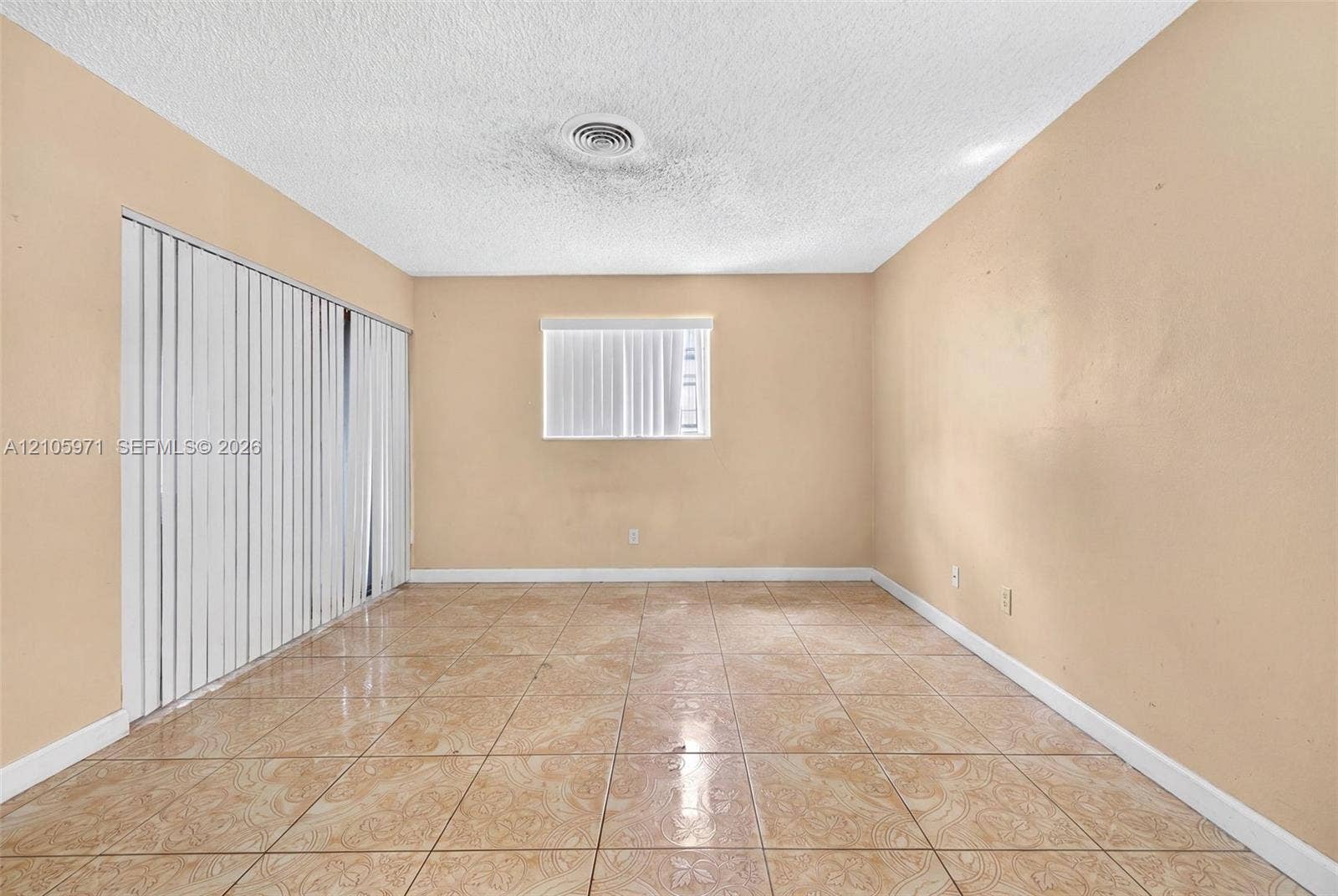 6604 Coconut Drive, Miramar, FL 33023 Room featuring ceramic tile flooring, vertical window blinds, and a large sliding glass door