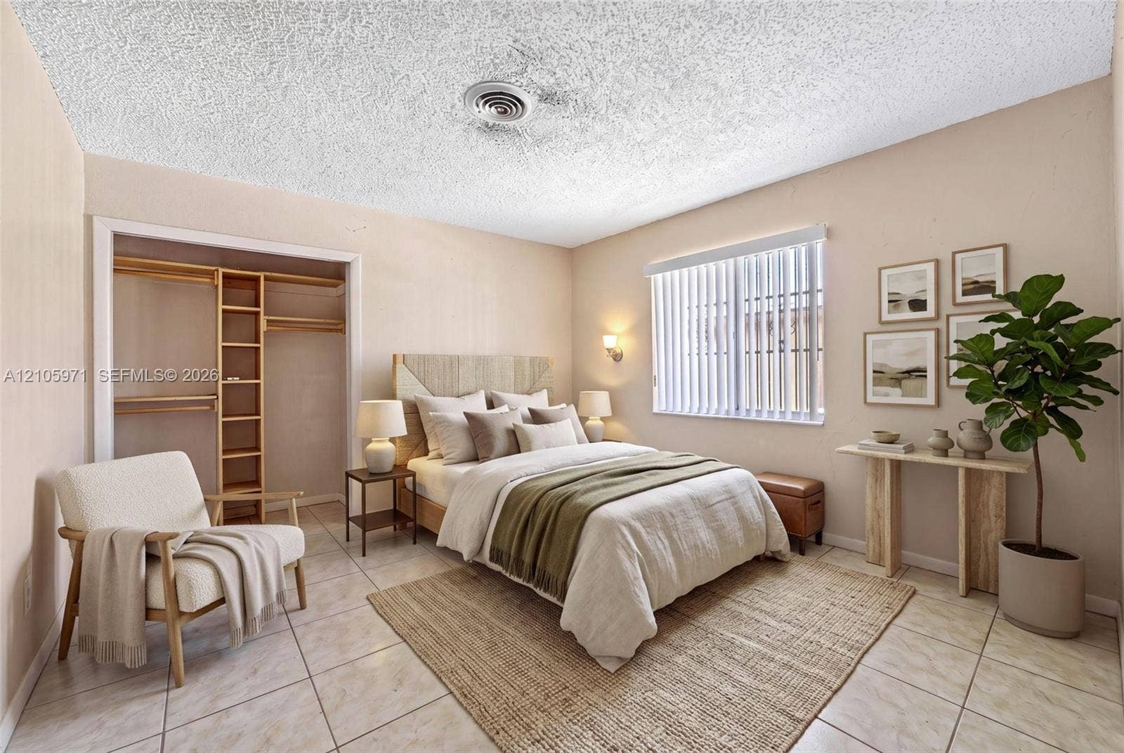 6604 Coconut Drive, Miramar, FL 33023 Neutral-toned interior featuring tile flooring, textured ceiling, built-in closet shelving, and vertical window blinds