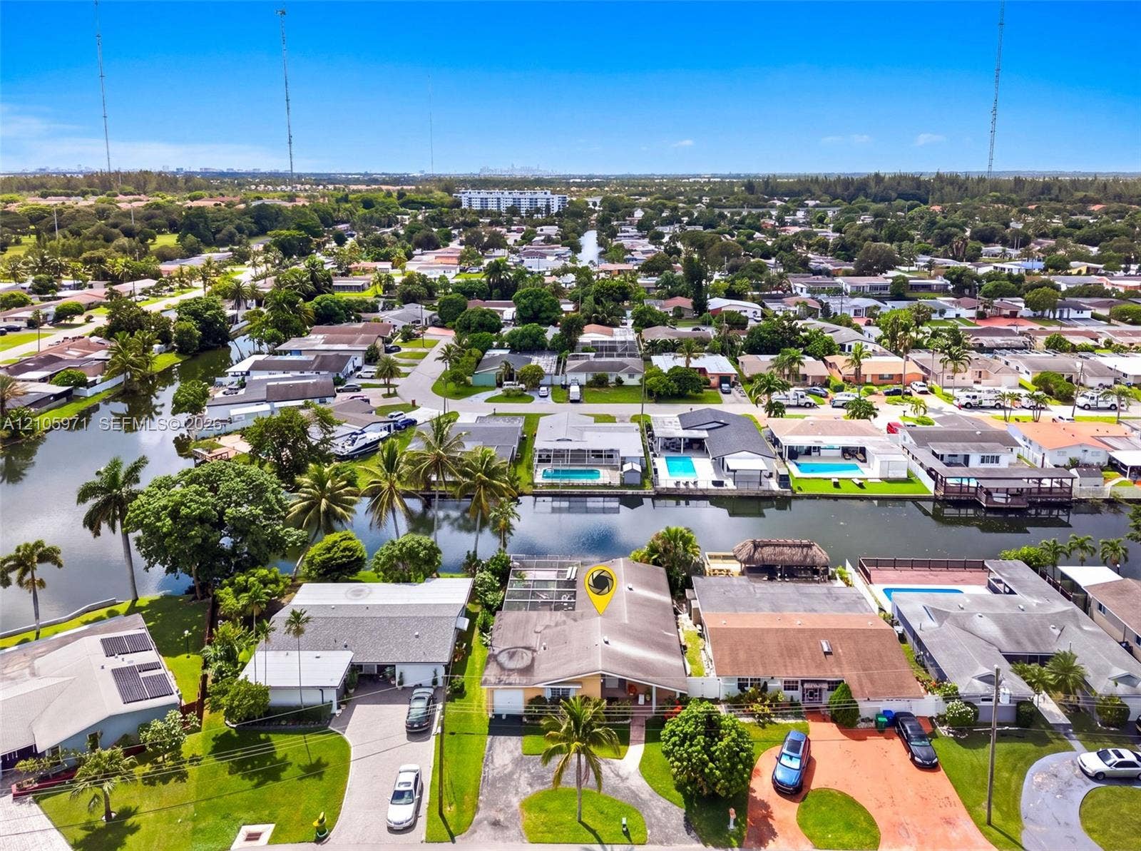 6604 Coconut Drive, Miramar, FL 33023 Aerial perspective featuring waterfront placement, screened rear enclosure, and mature tropical landscaping