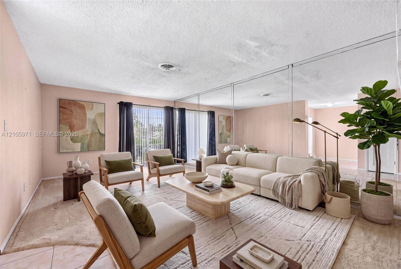 6604 Coconut Drive, Miramar, FL 33023 Living area featuring floor-to-ceiling wall mirror panels, sliding glass doors, and light-toned carpeting