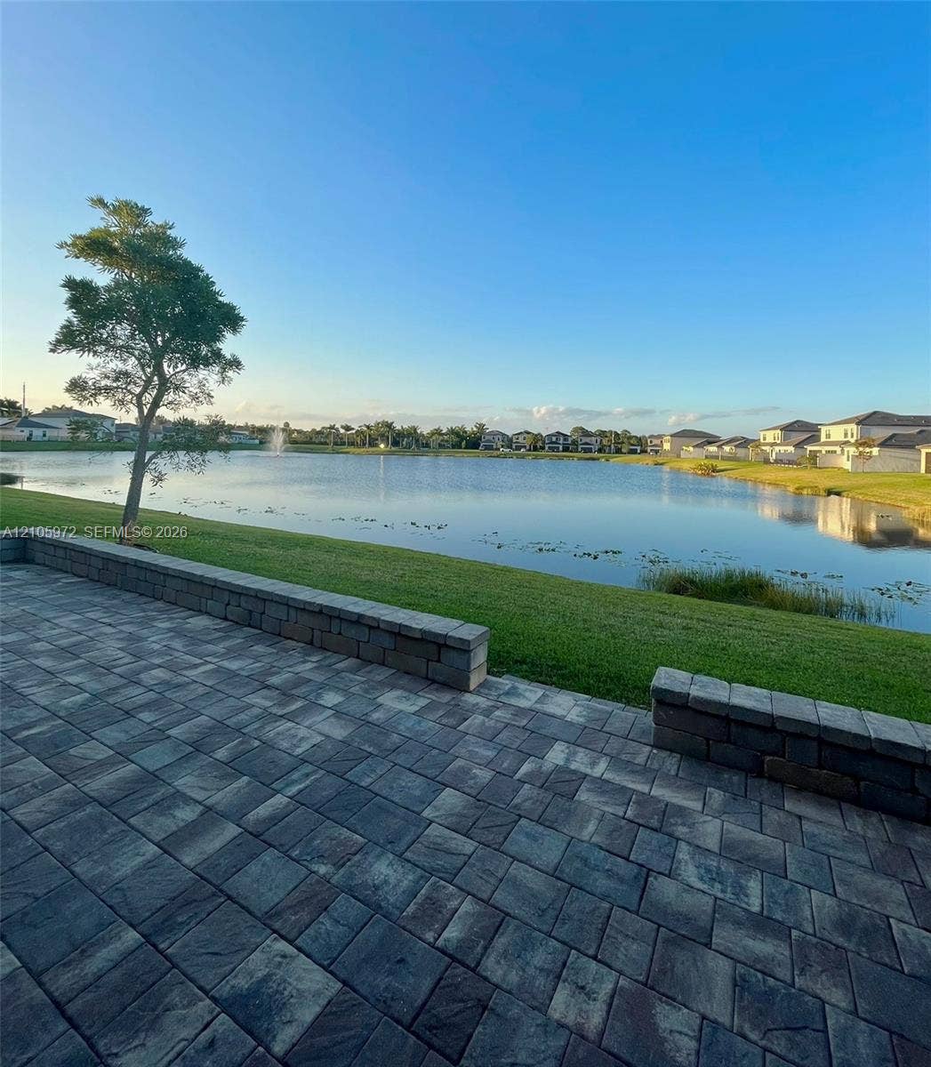 6220 Oceanaire Way, Lake Worth, FL 33467 Paver patio featuring integrated stone block seating walls and expansive waterfront exposure