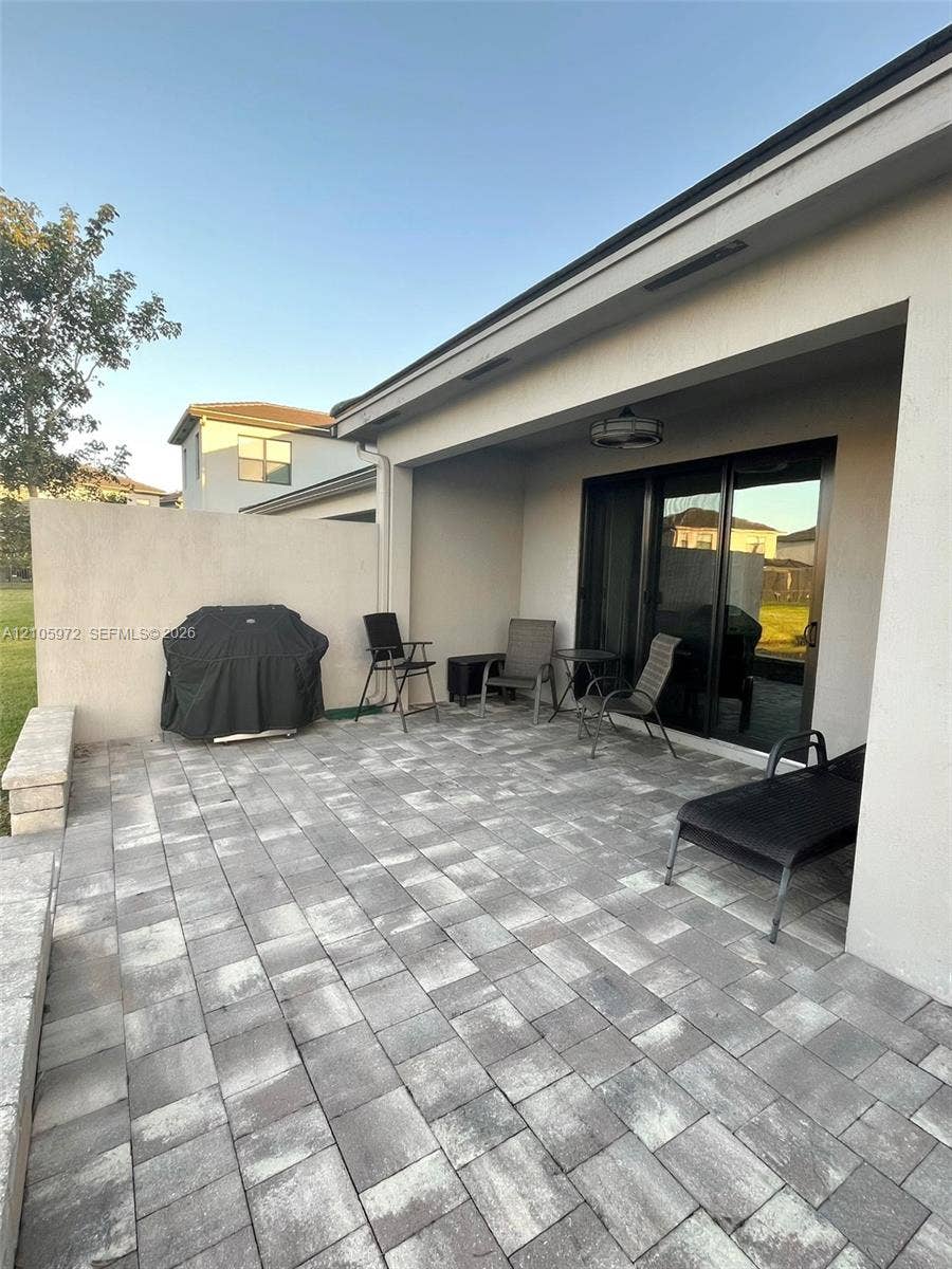 6220 Oceanaire Way, Lake Worth, FL 33467 Covered patio featuring concrete paver flooring, a perimeter masonry privacy wall, and recessed ceiling lighting