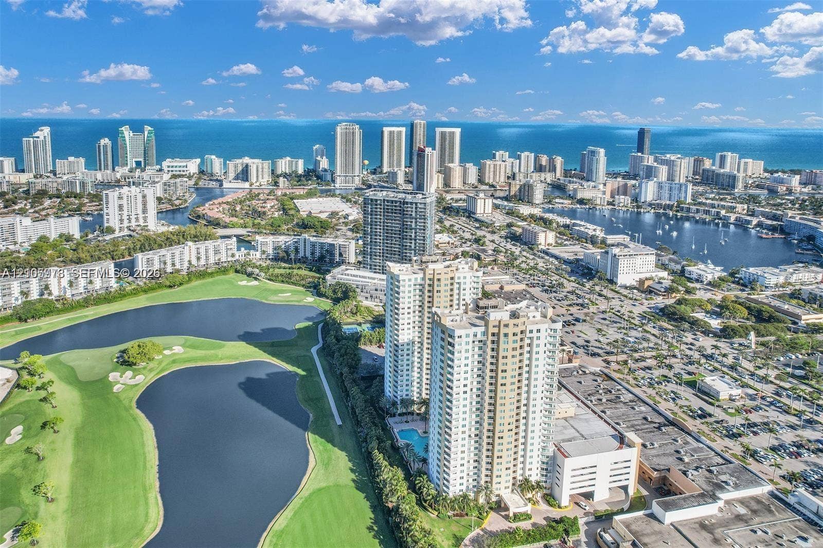 1755 E Hallandale Beach Boulevard, #704E, Hallandale Beach, Hallandale Beach, FL 33009 Aerial perspective featuring coastal city skyline, proximity to waterways, and adjacent expansive golf course grounds