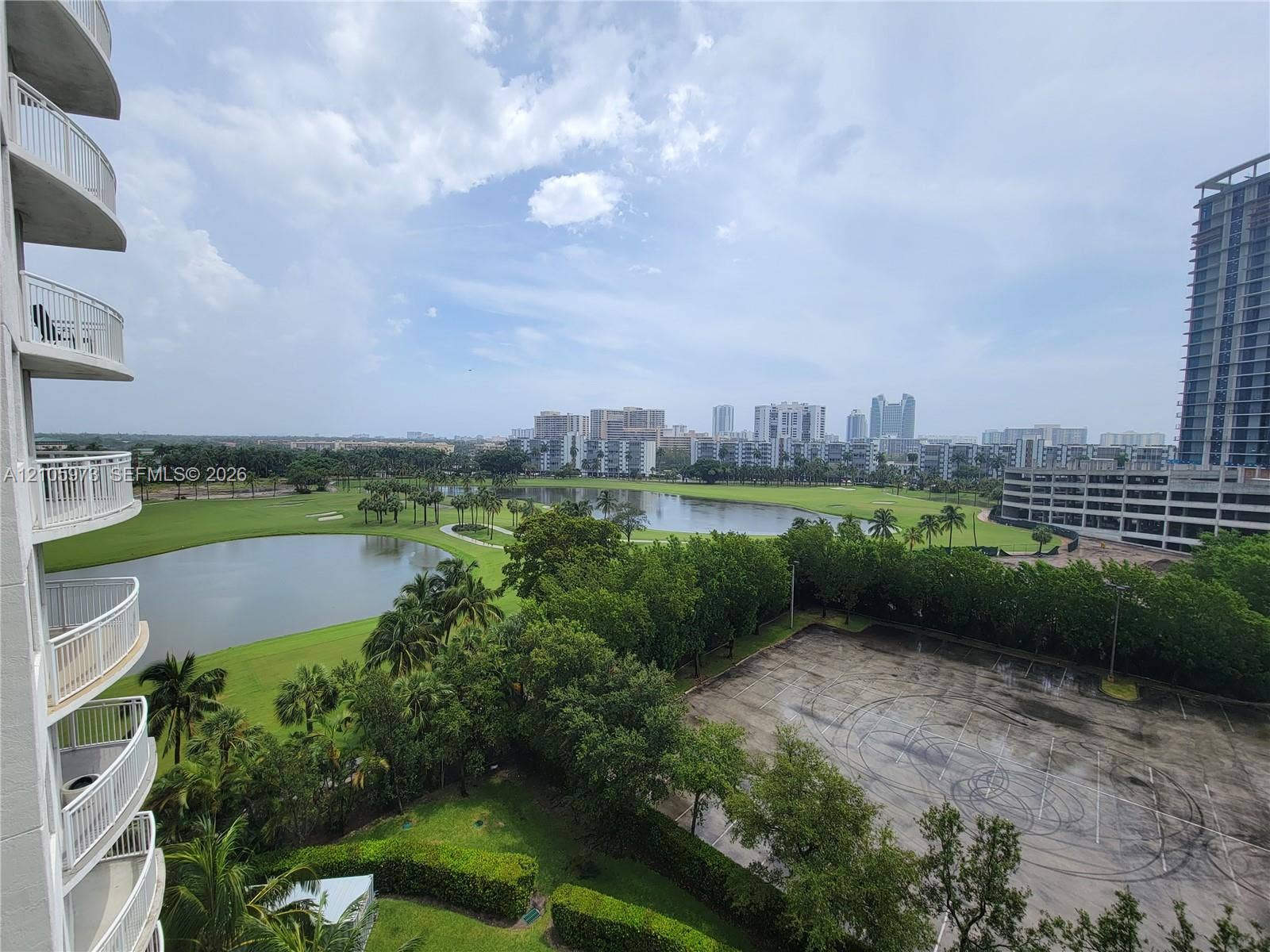 1755 E Hallandale Beach Boulevard, #704E, Hallandale Beach, Hallandale Beach, FL 33009 High-rise exterior with stacked balconies, overlooking a lake, manicured green space, and urban landscape
