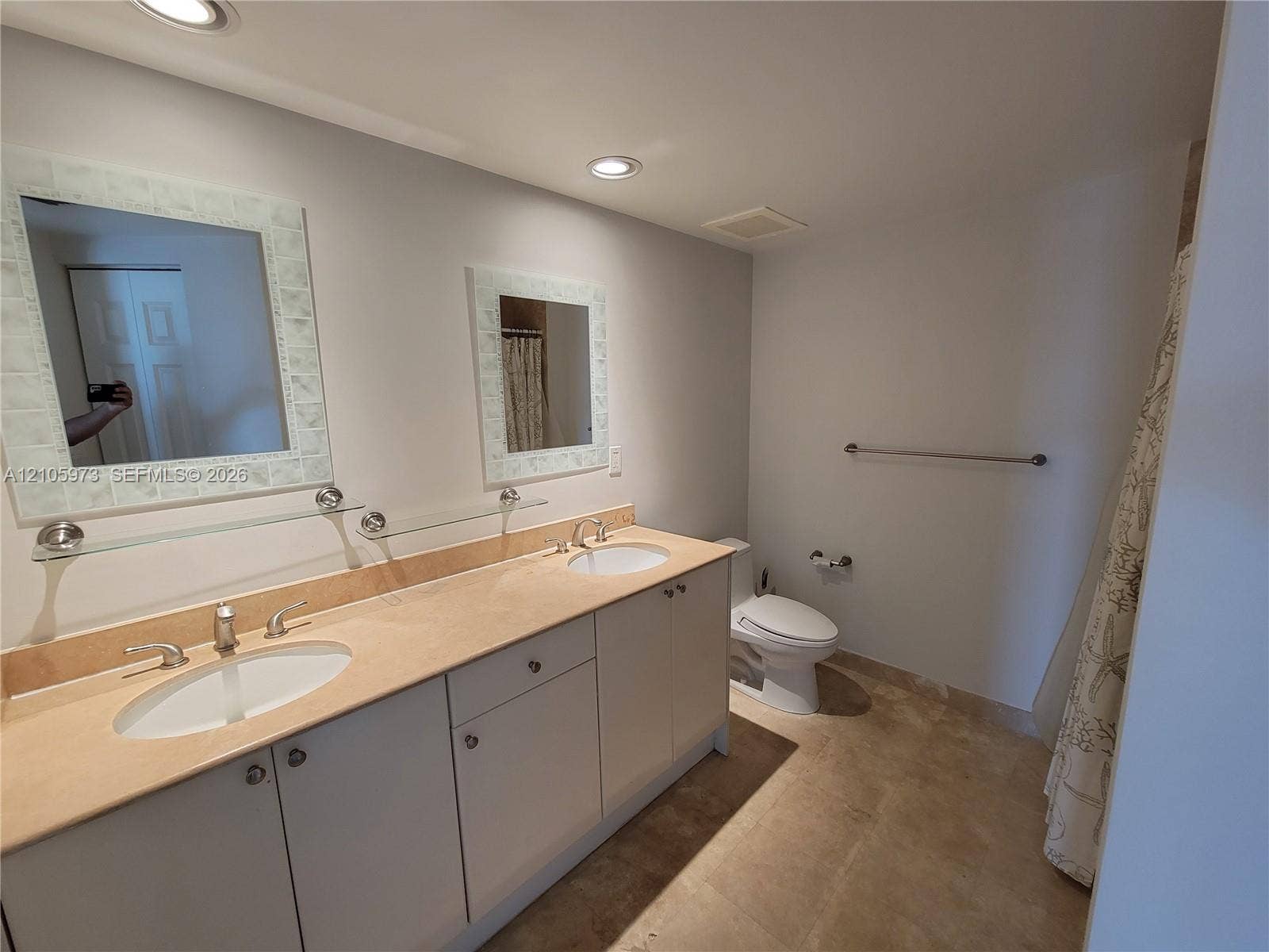 1755 E Hallandale Beach Boulevard, #704E, Hallandale Beach, Hallandale Beach, FL 33009 Dual-sink vanity with a stone countertop, recessed lighting, and twin wall-mounted mirrors with decorative frames