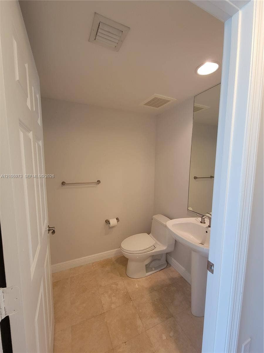 1755 E Hallandale Beach Boulevard, #704E, Hallandale Beach, Hallandale Beach, FL 33009 Powder room featuring a pedestal sink, polished stone flooring, recessed lighting, and a wall-mounted mirror