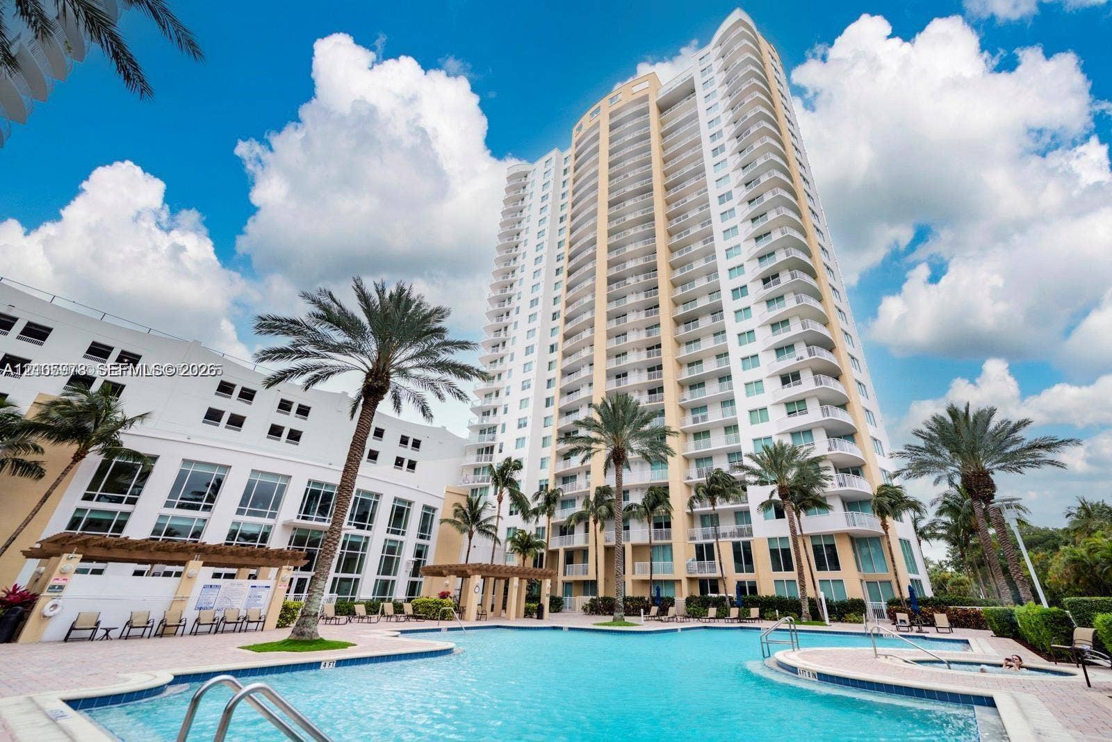 1755 E Hallandale Beach Boulevard, #704E, Hallandale Beach, Hallandale Beach, FL 33009 High-rise residential building featuring expansive private balconies, a multi-level swimming pool, integrated spa, and shaded pergola structures